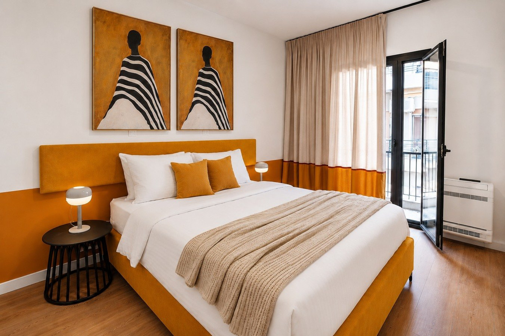 Bedroom with orange headboard and balcony