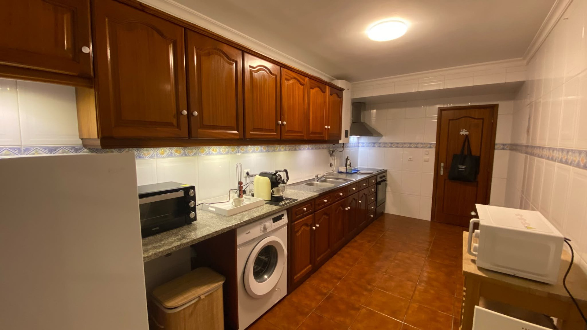 Fully equipped kitchen with wood cabinets