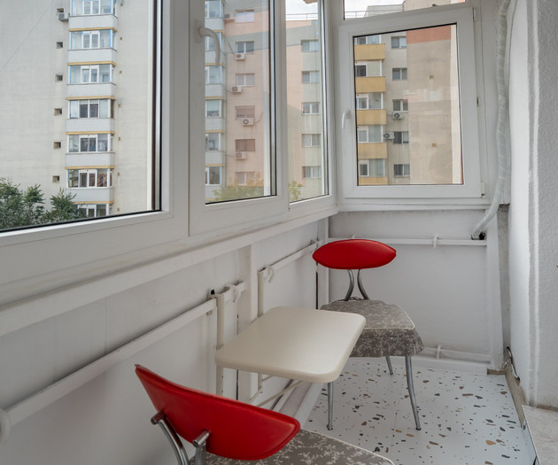 Enclosed balcony with chairs