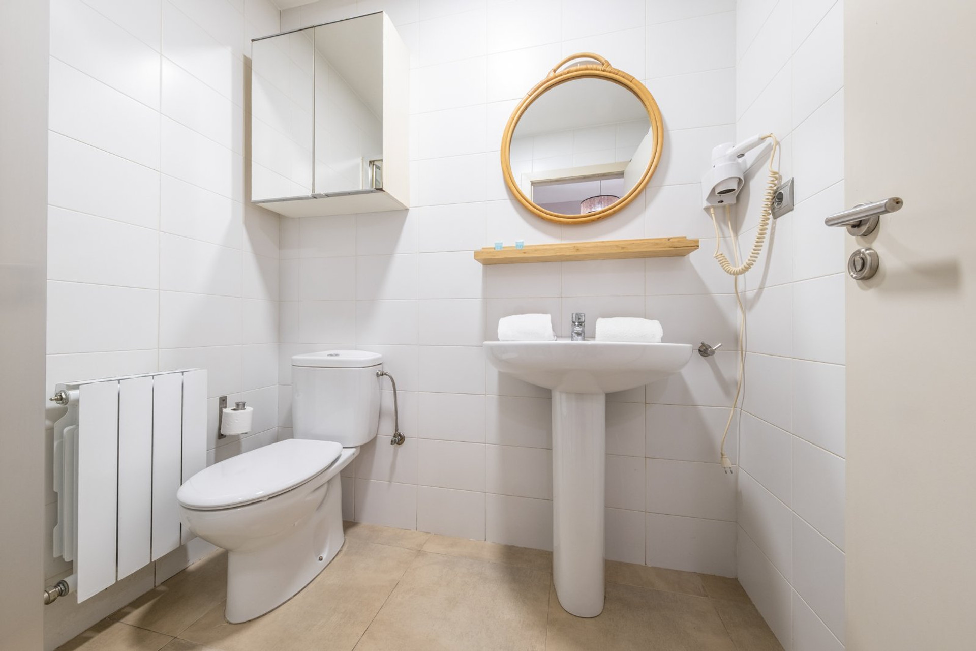 Clean white bathroom with mirror