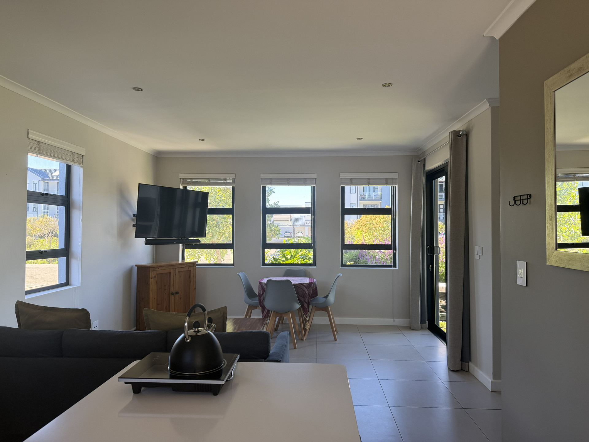 Bright living dining area with TV