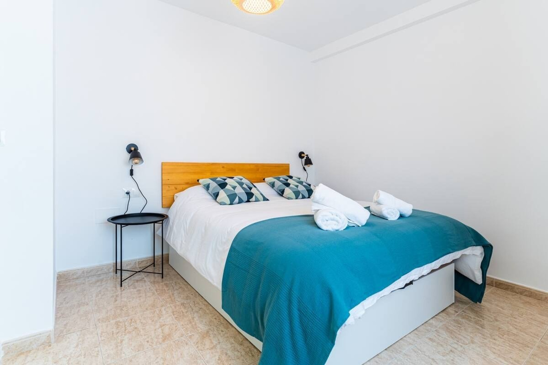 Bedroom with teal accent bedding
