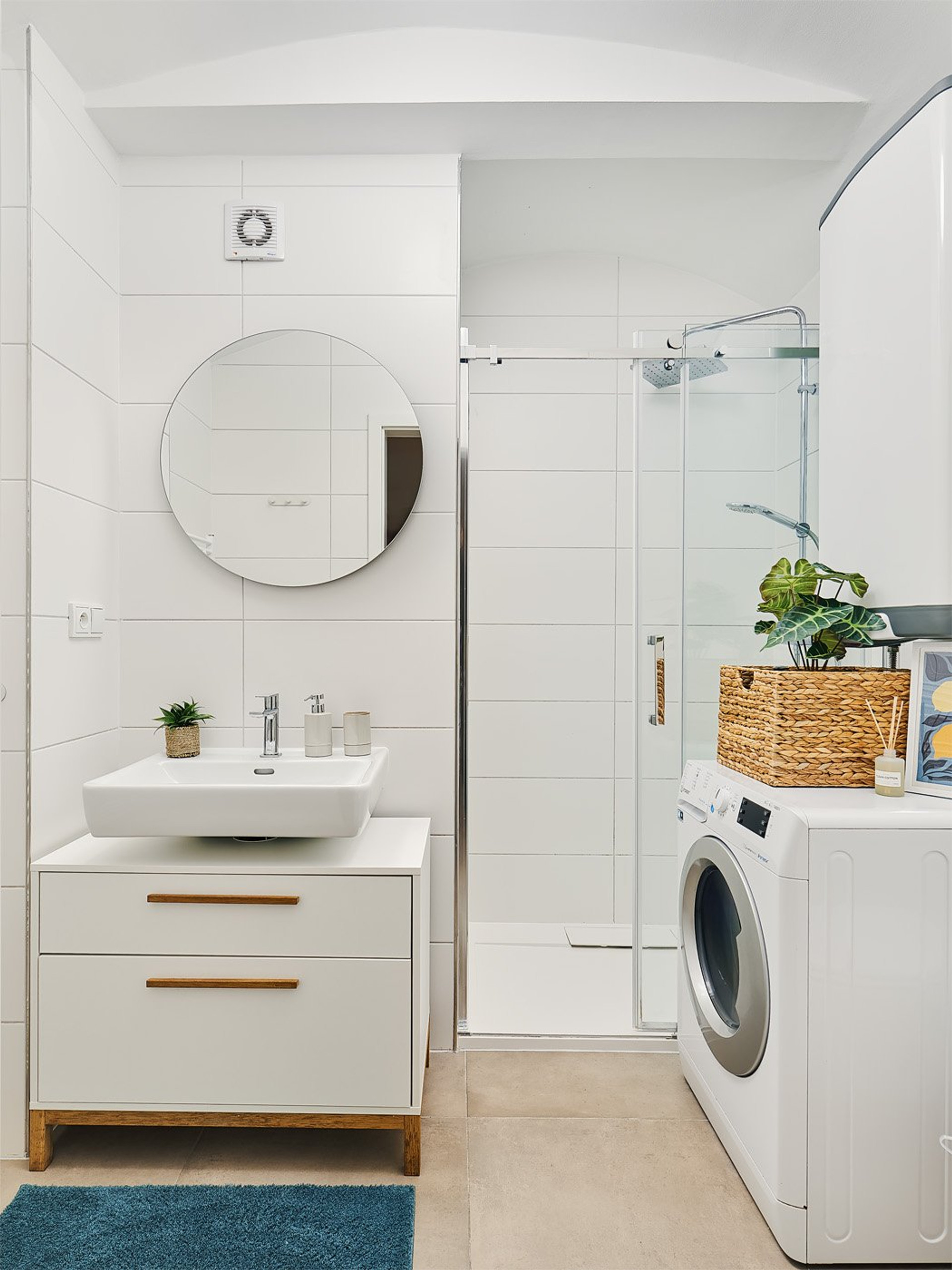 White bathroom with shower and washer