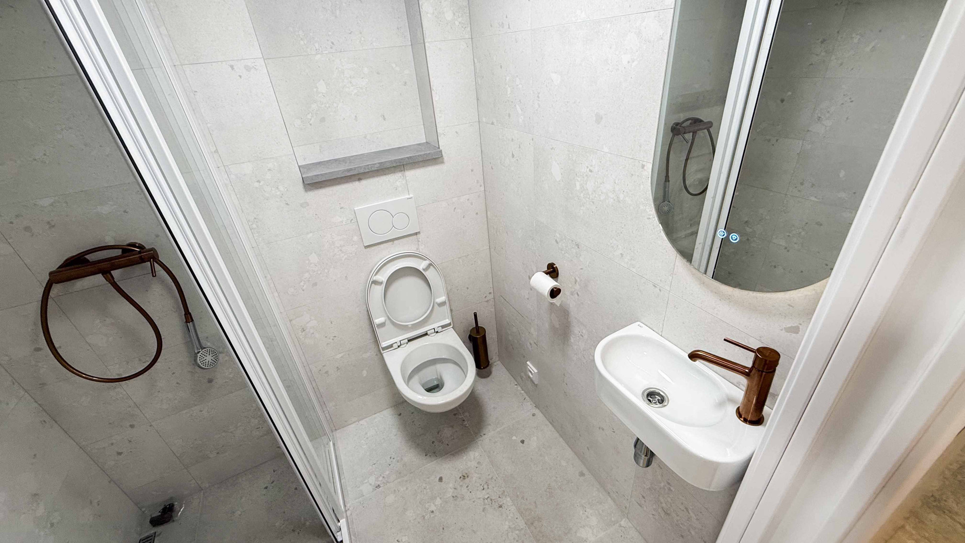 Compact bathroom with toilet and sink