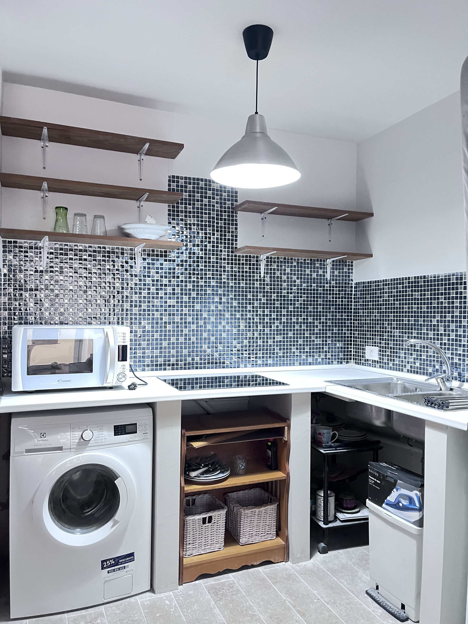 Kitchen with washing machine and microwave