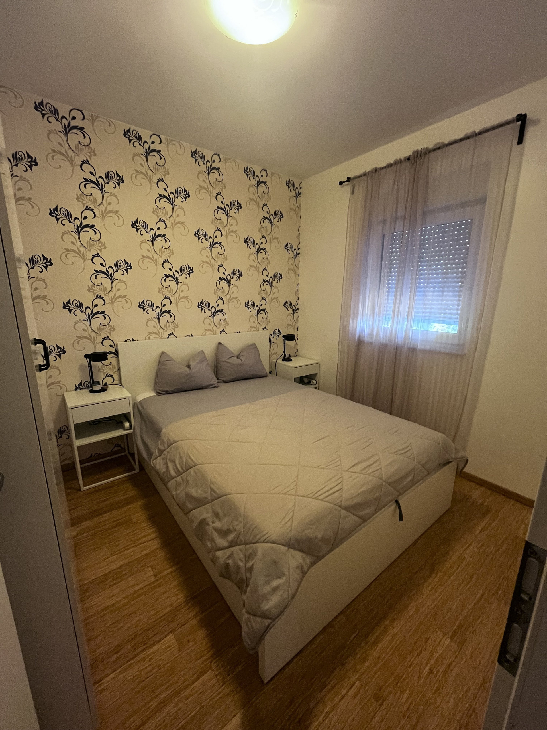Bedroom with floral wallpaper accent wall