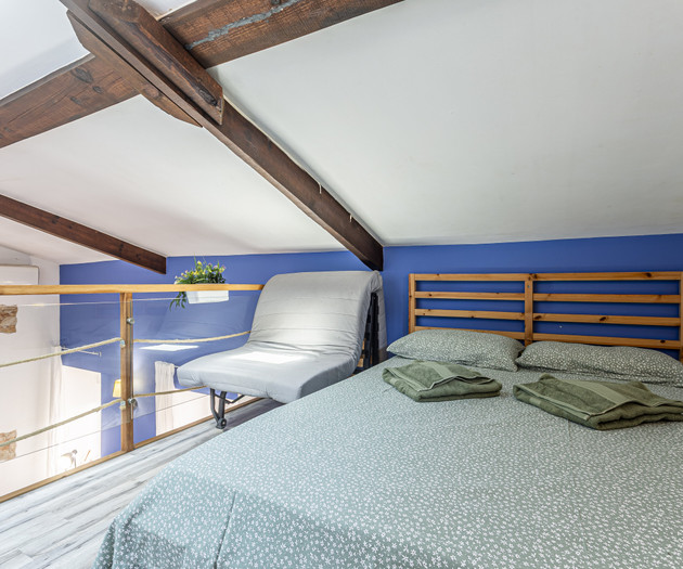 Loft bed with wooden beams