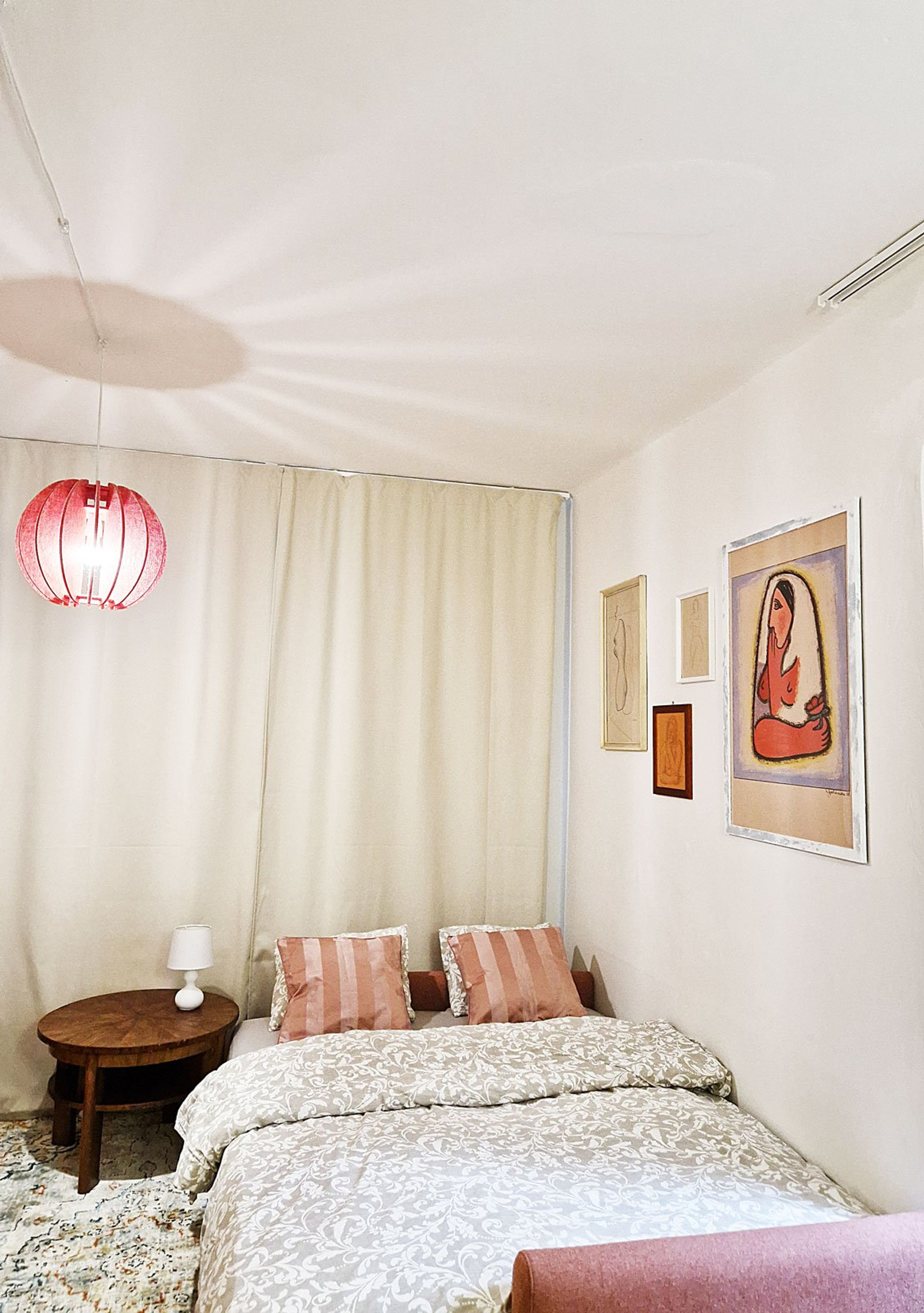 Bedroom with art and red lamp