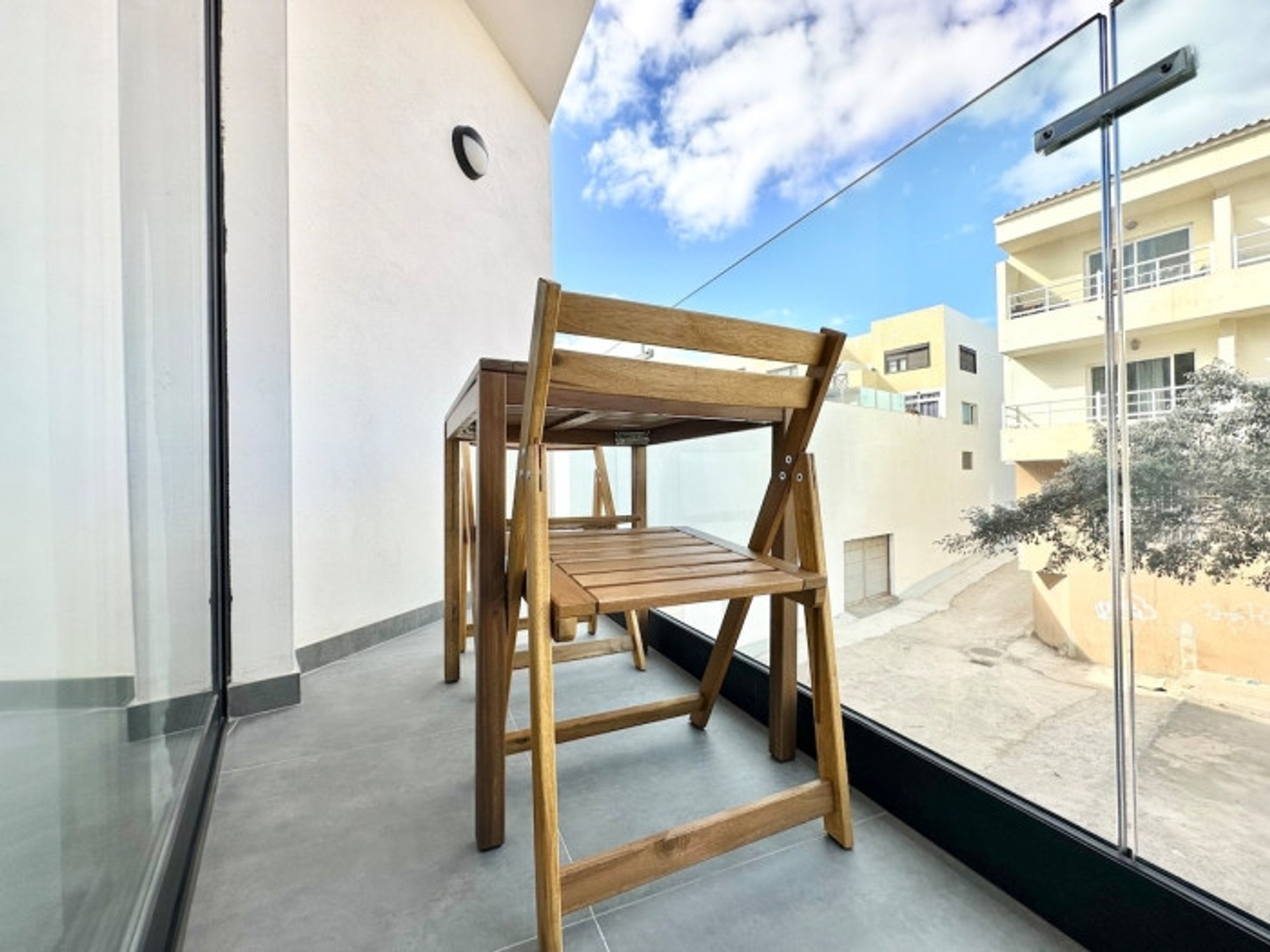 Balcony with wooden furniture