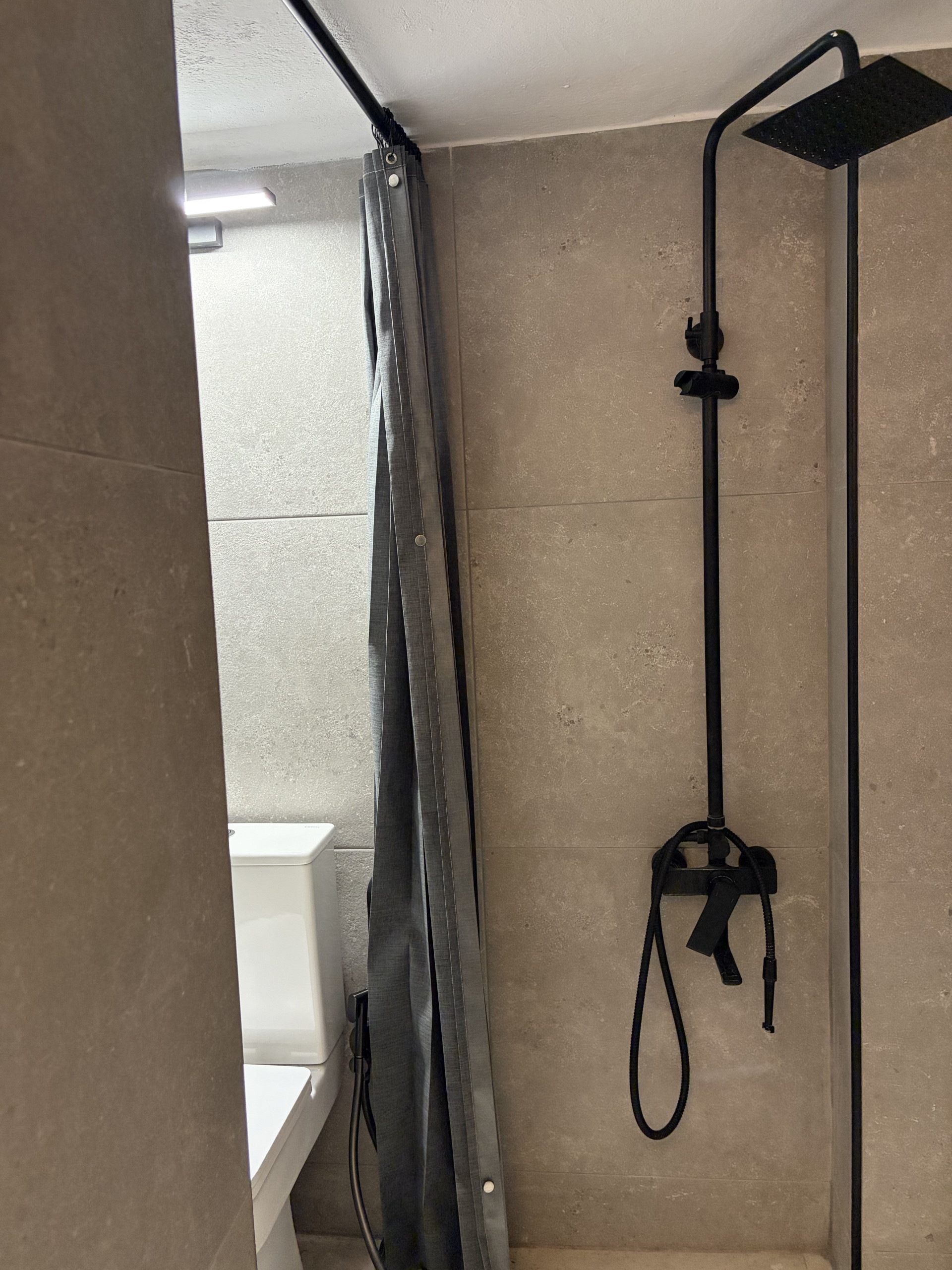 Bathroom with rain shower fixture