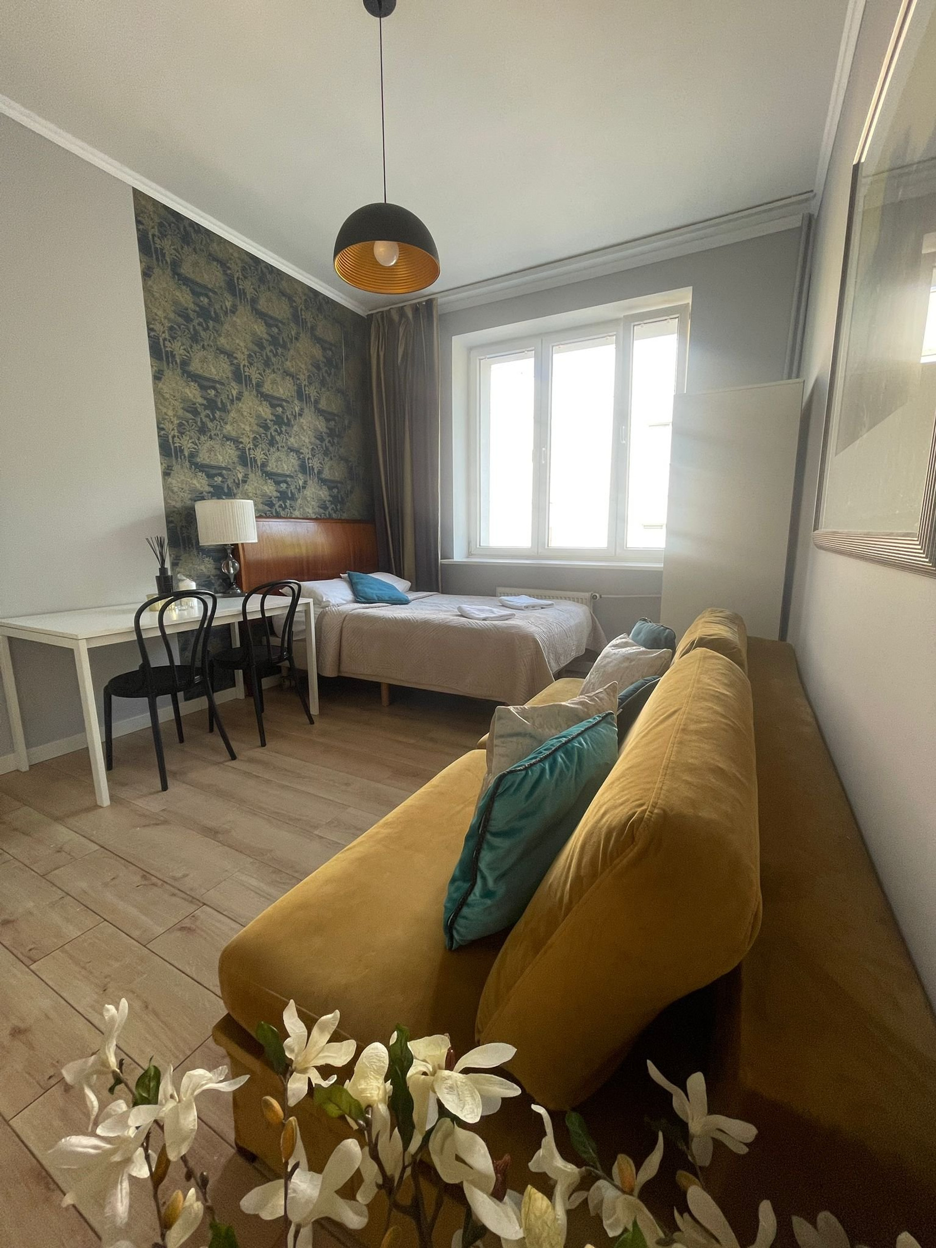 Bright studio with sofa and bed