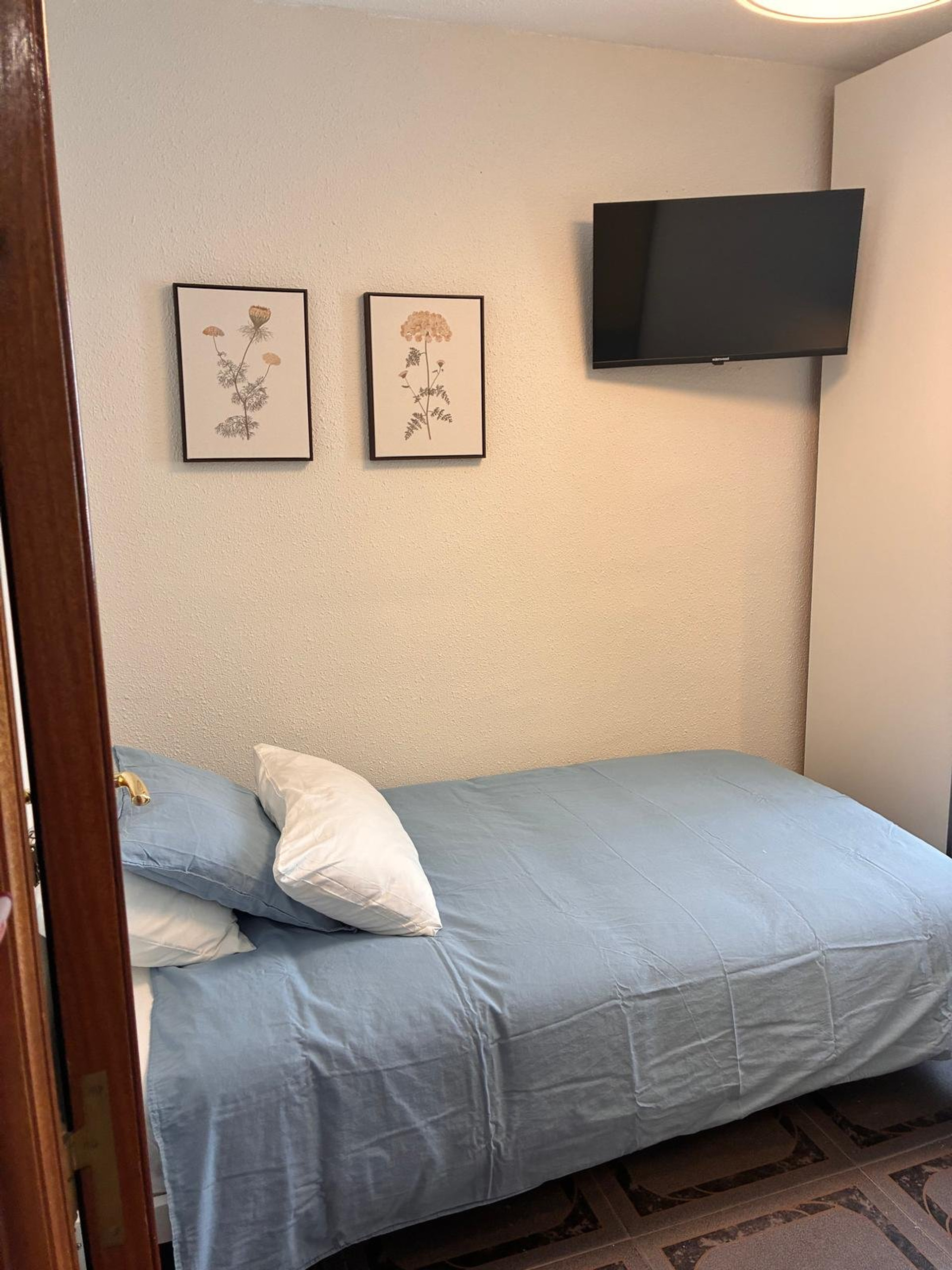 Bedroom with TV and art