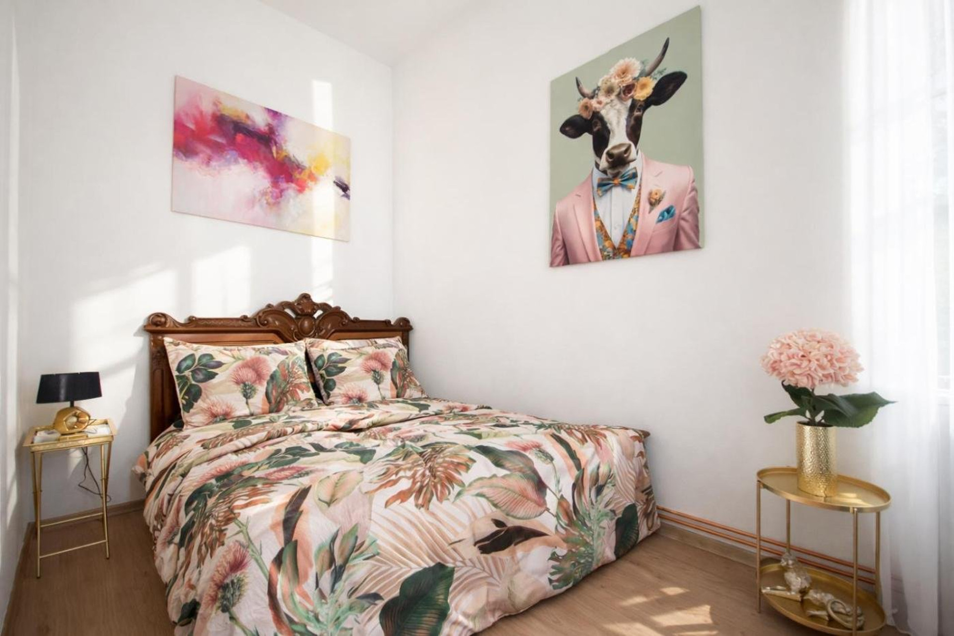 Bedroom with floral bedding and art