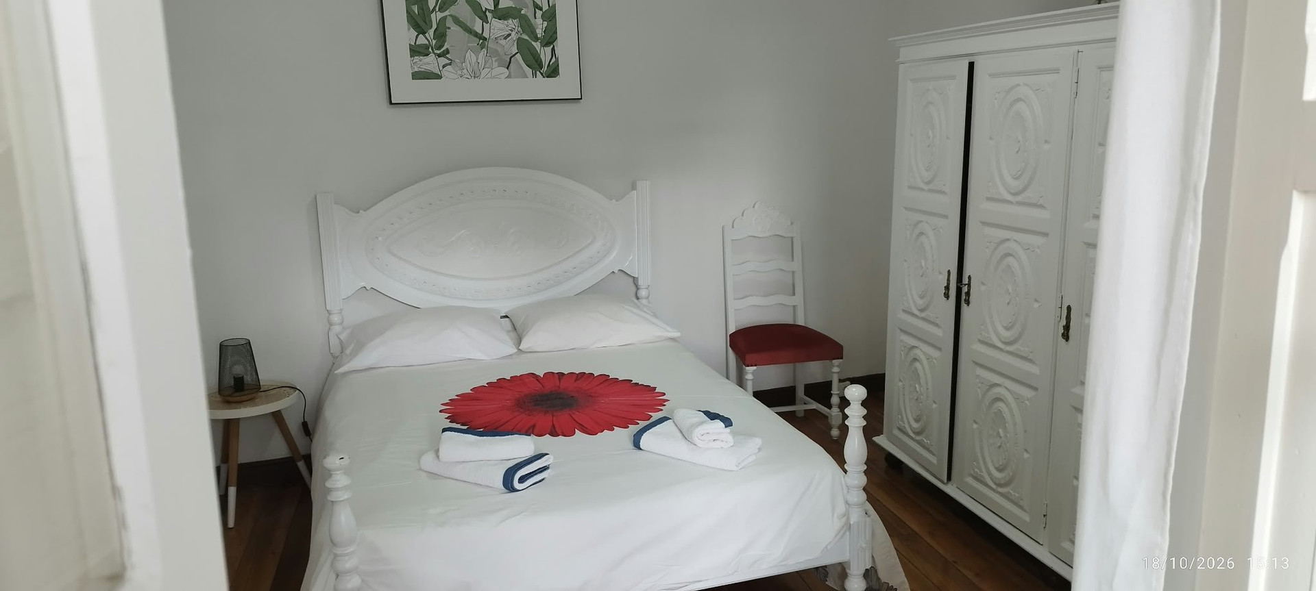 White bedroom with ornate headboard