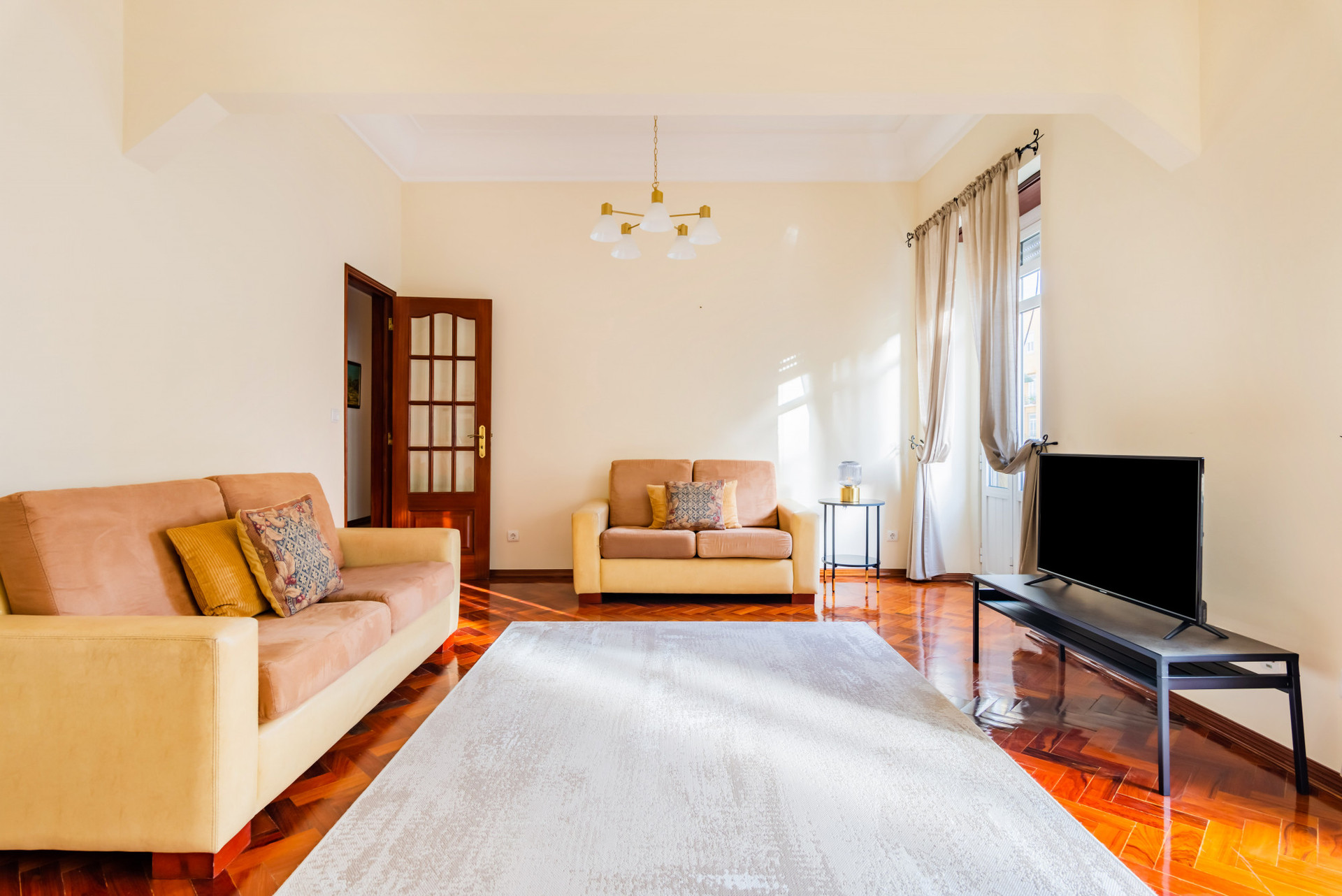 Living Room with Flat-Screen TV and Balcony