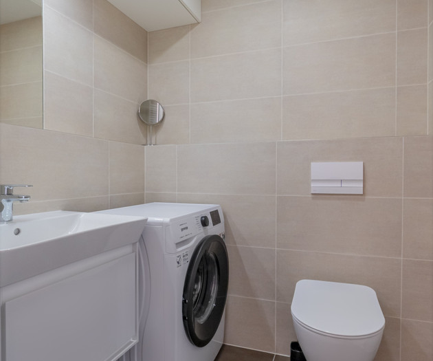 Bathroom with washer and toilet