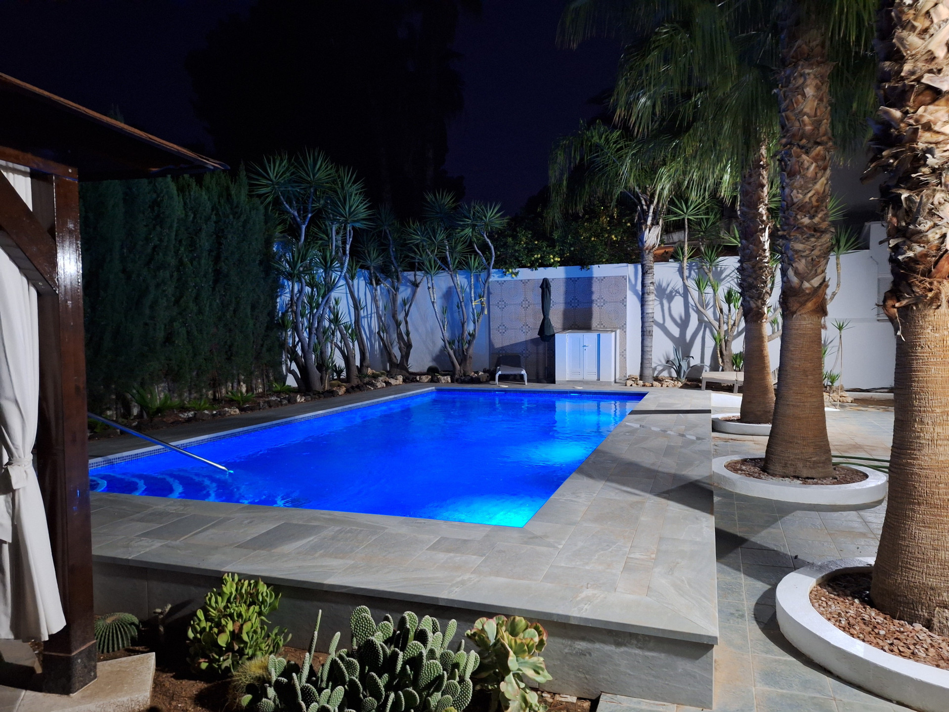 Pool illuminated blue at night