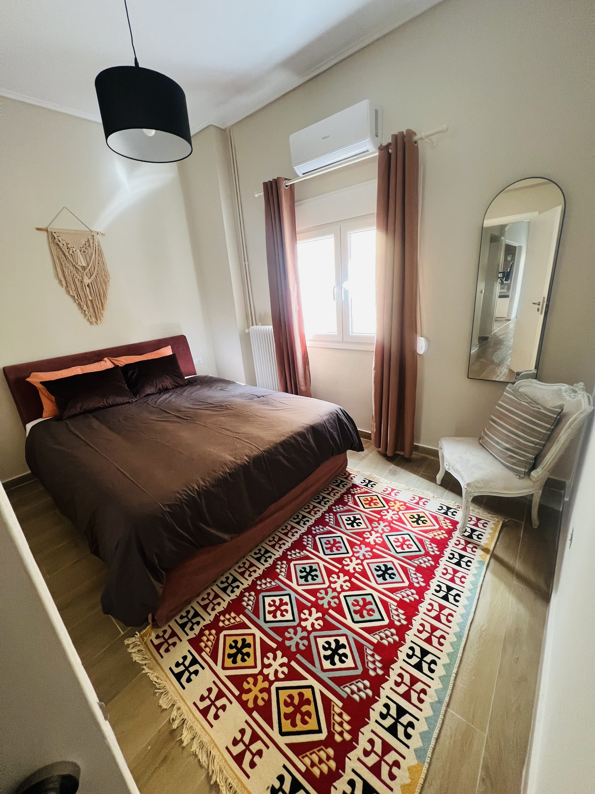 Bedroom with double bed and kilim