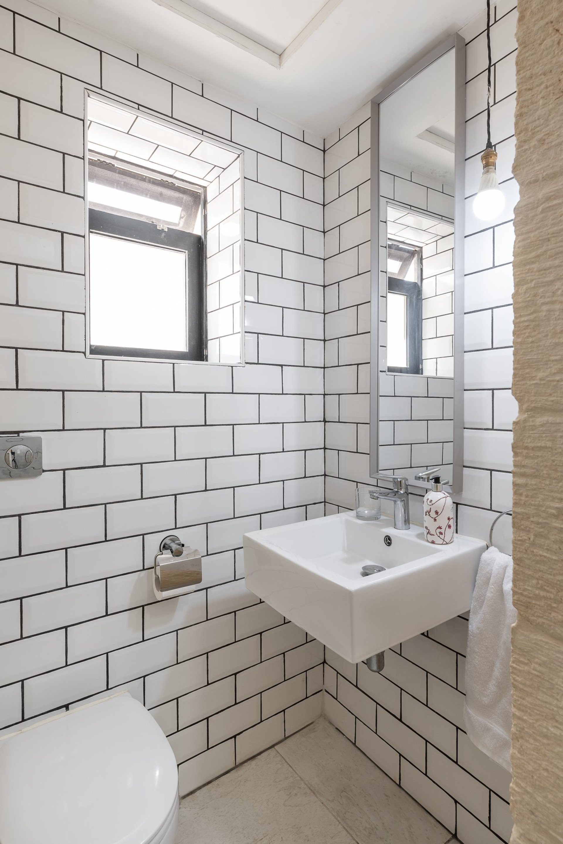 Bathroom with subway tile walls