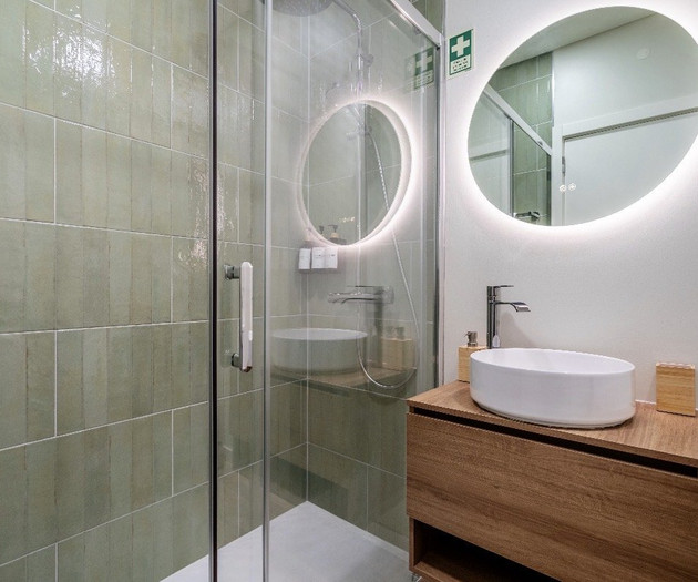 Bathroom with green tiled shower