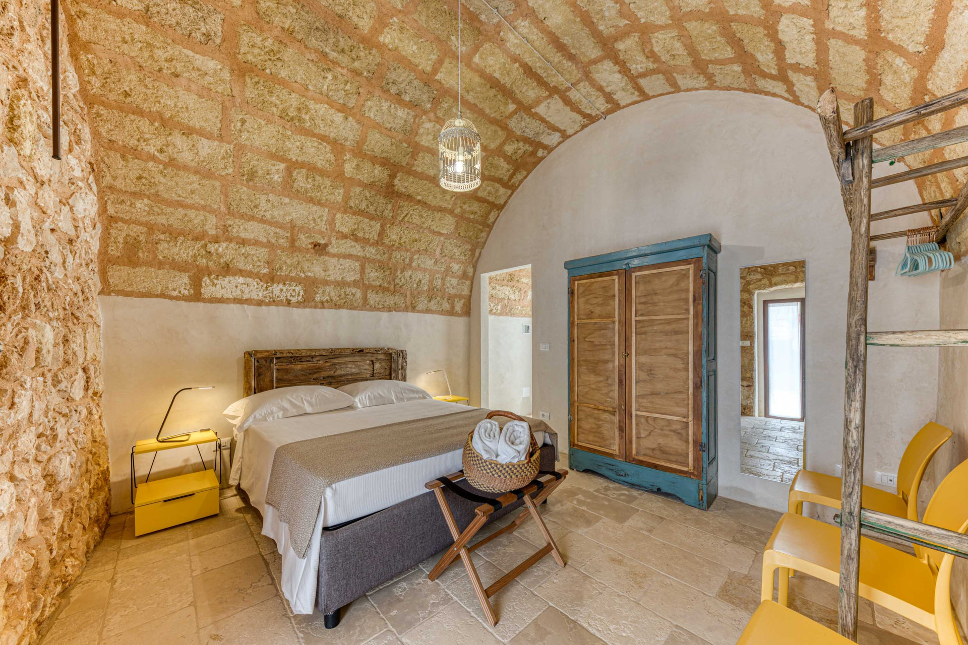 Vaulted stone bedroom with wardrobe