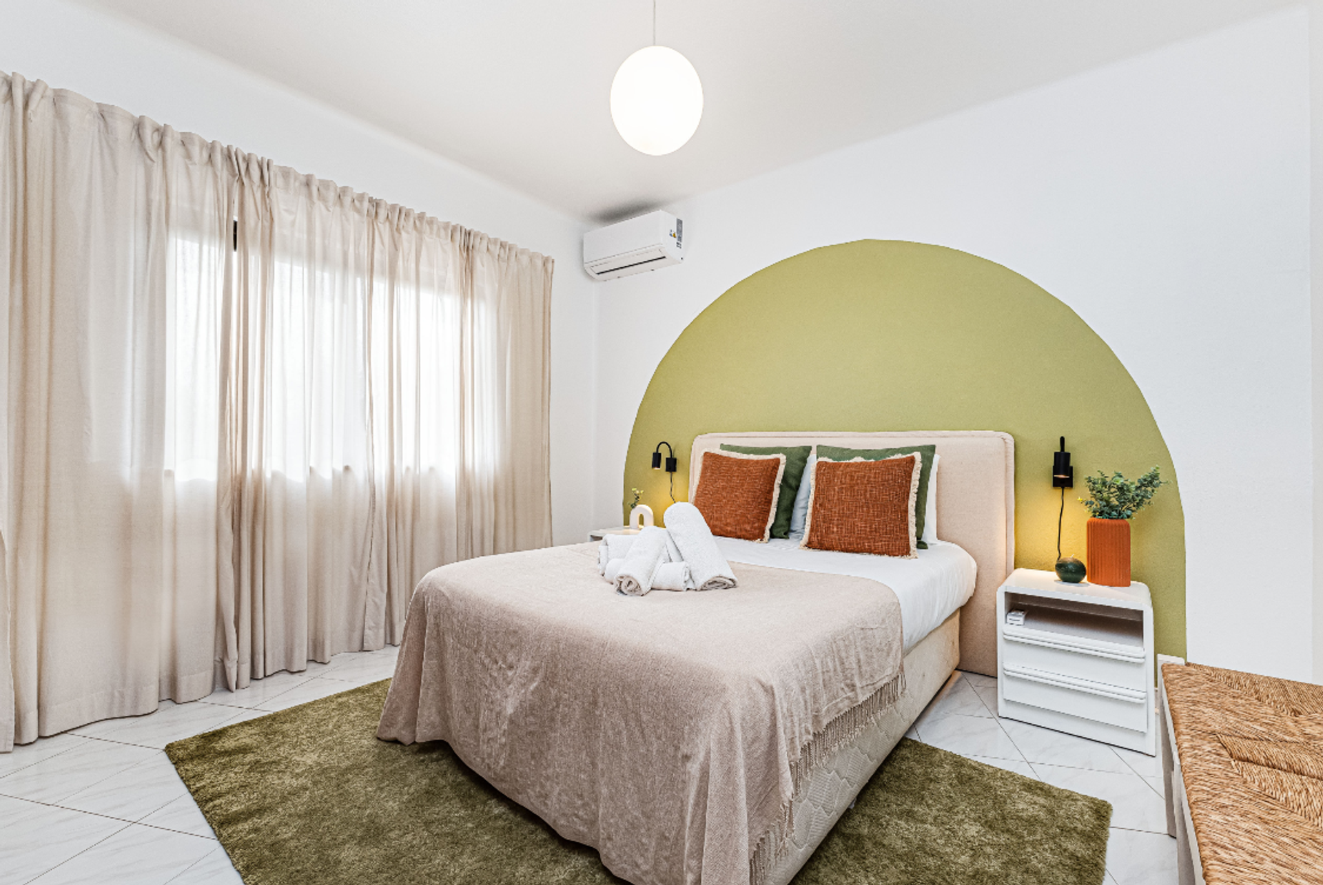 Bedroom with green arch headboard