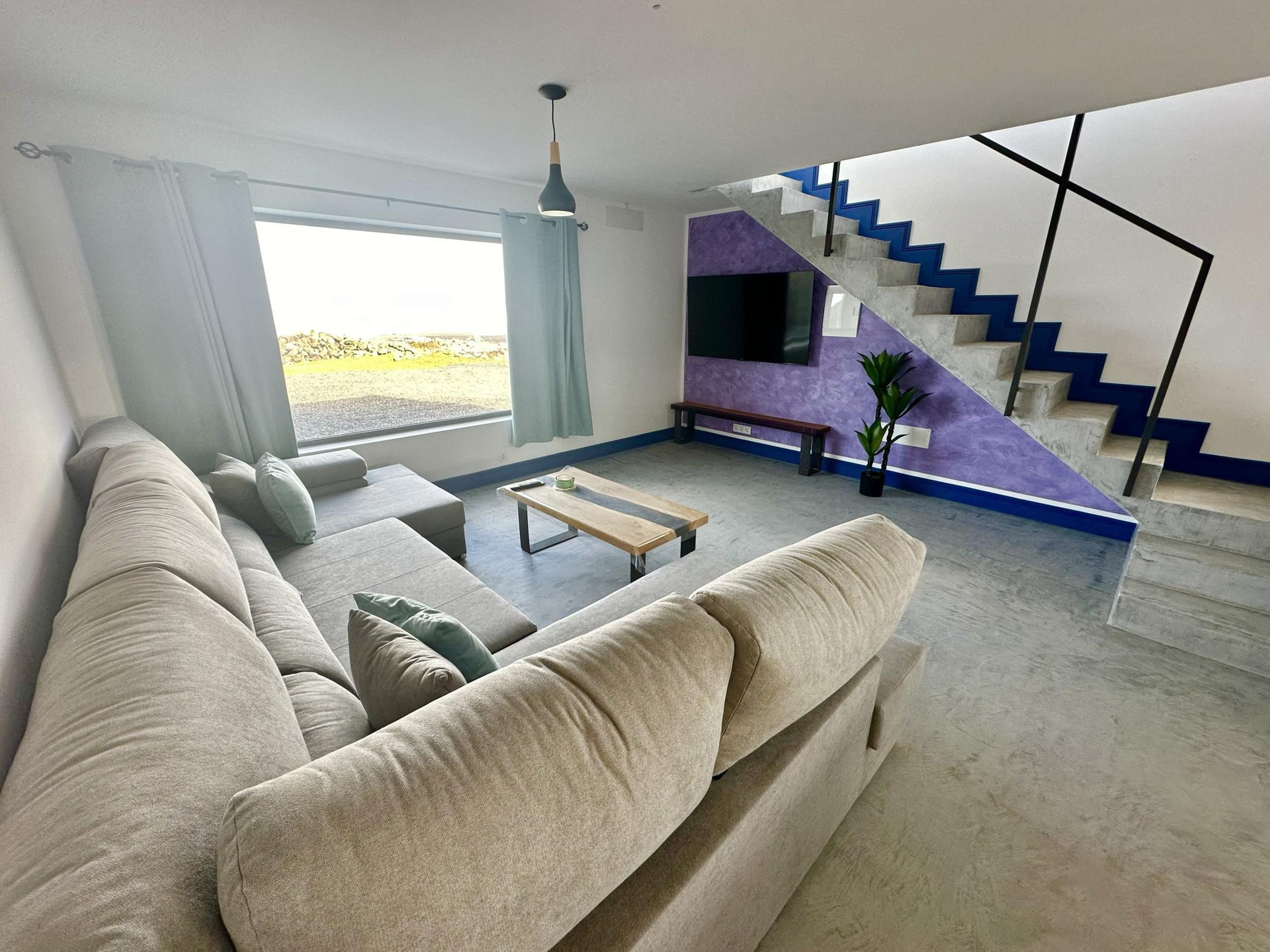 Living room sofa staircase TV wall