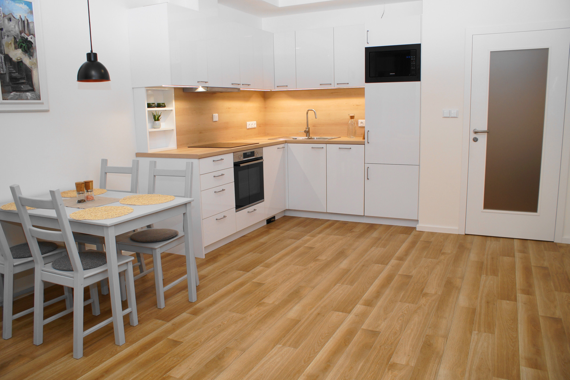 Modern white kitchen with dining
