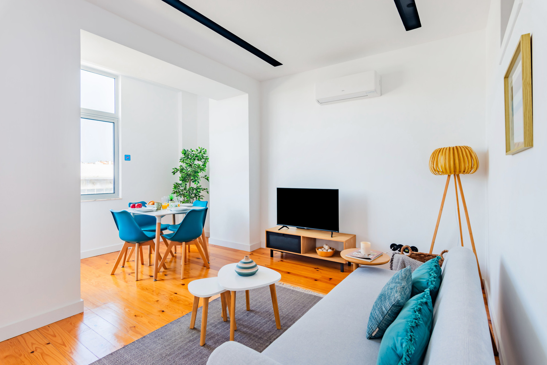 Living Room with TV, Dining Table and Air Conditioner. Fully Equipped Open Space Kitchen.