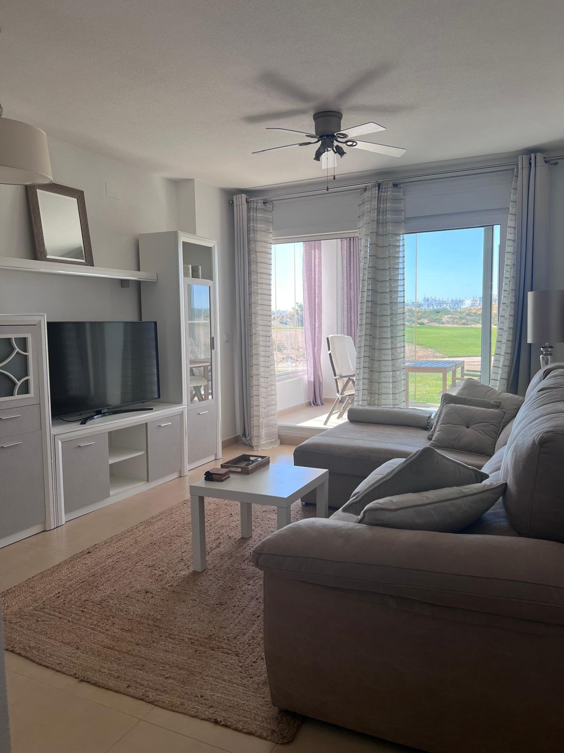 Bright living room with golf views