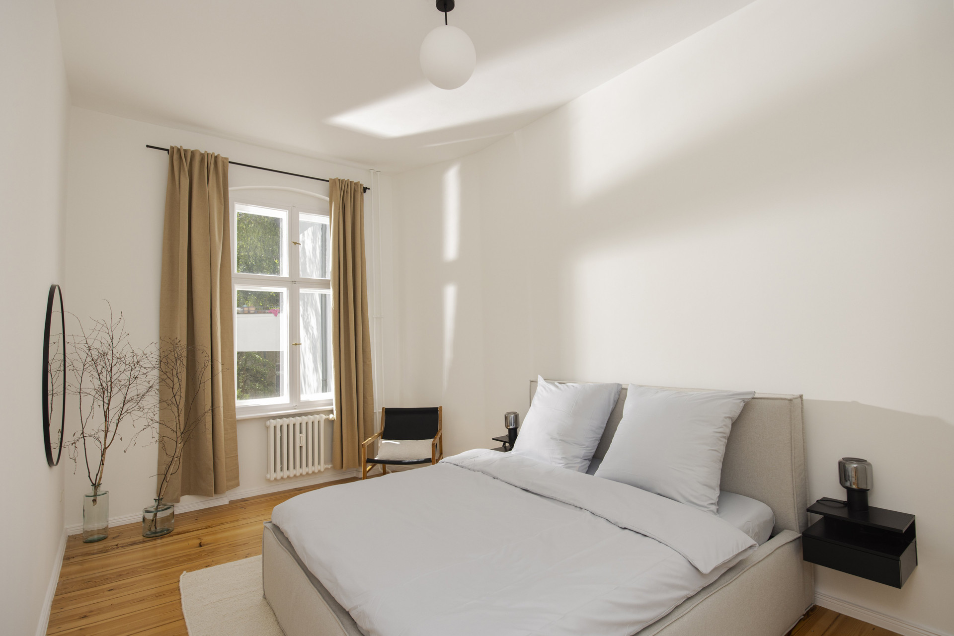 Bright bedroom double bed wooden floor