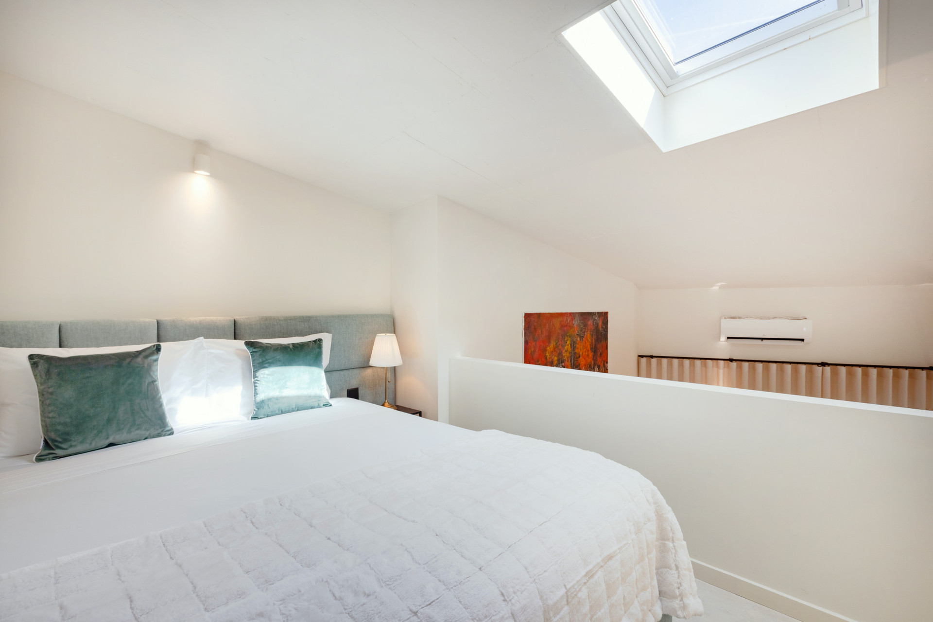 Bedroom in the mezzanine with a double bed and wardrobe