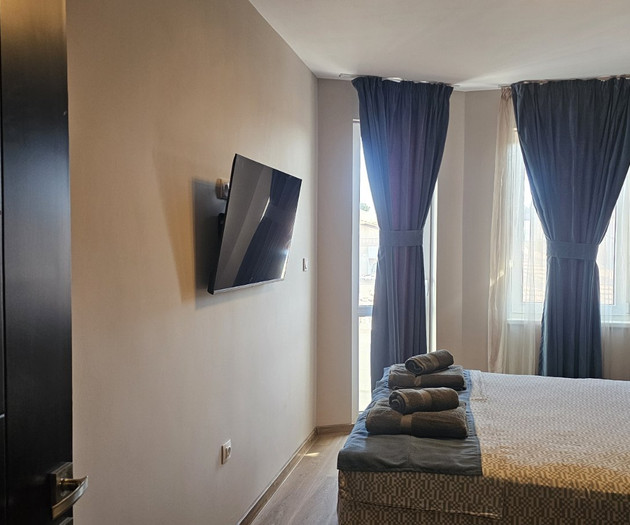 Bedroom with TV and curtains