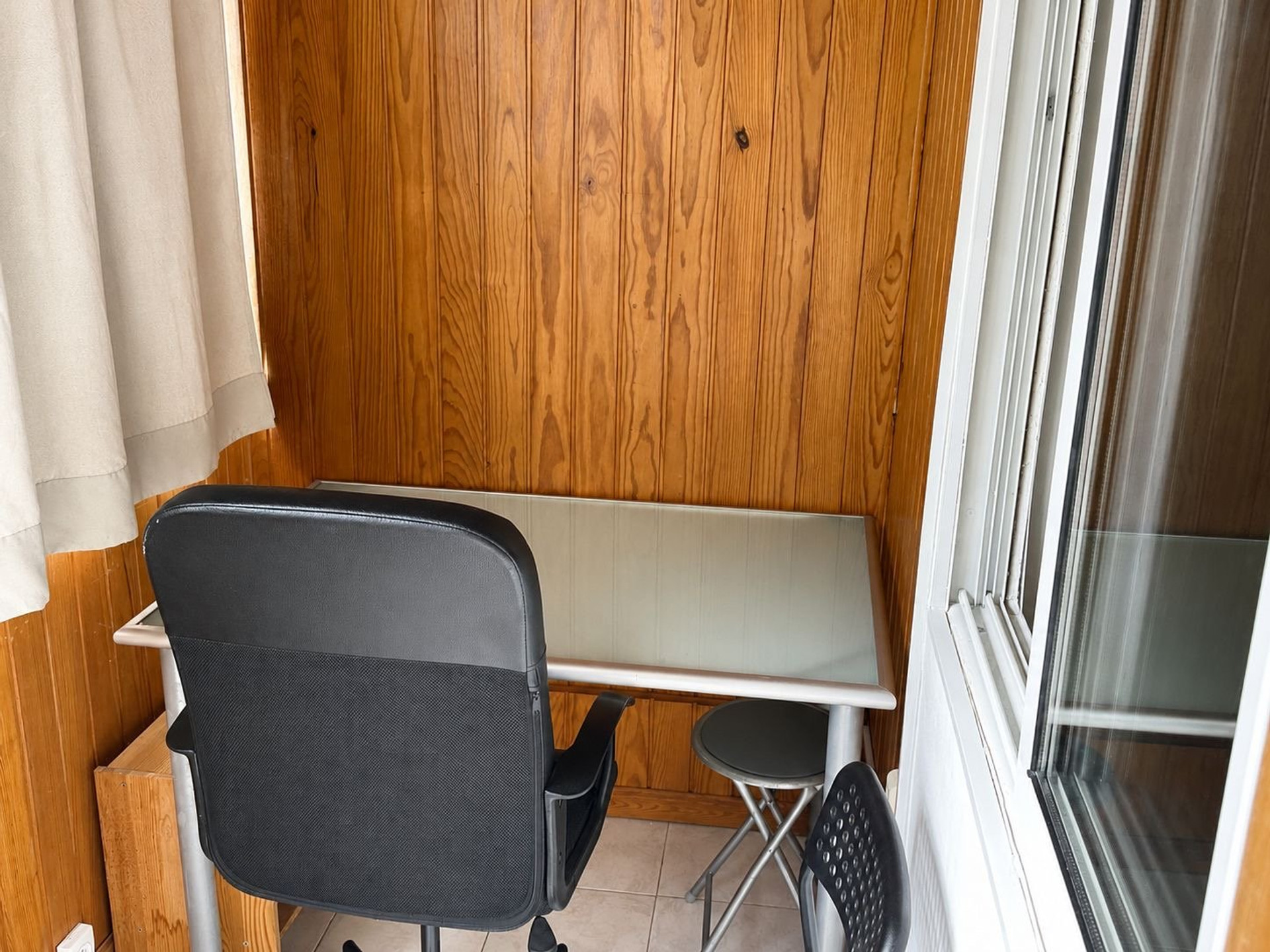 Enclosed porch with desk and chair