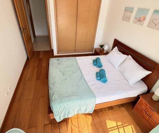 Bedroom with double bed towels