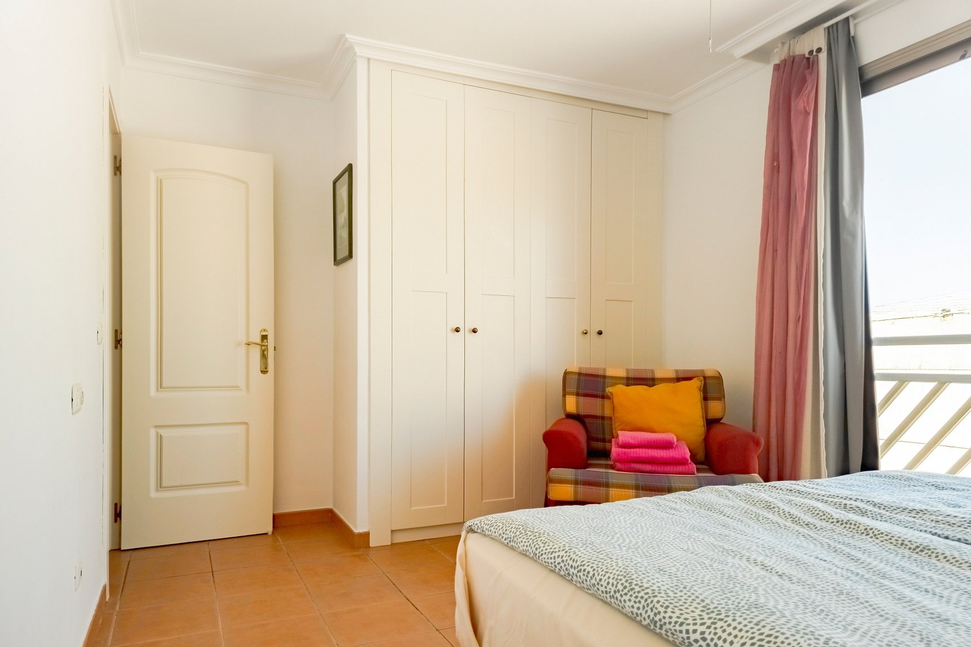 Bedroom with wardrobe and armchair