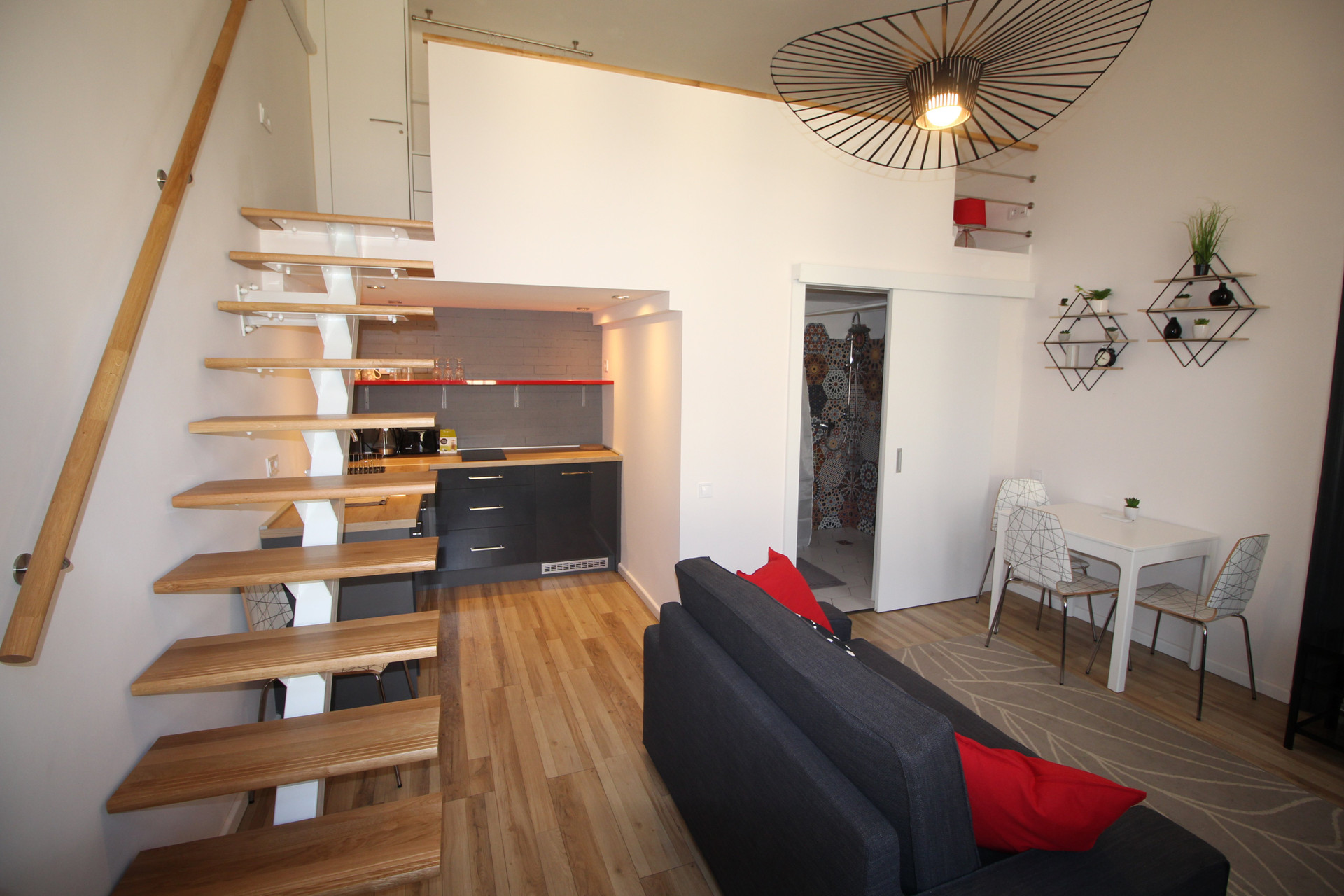 Living area with mezzanine staircase kitchen