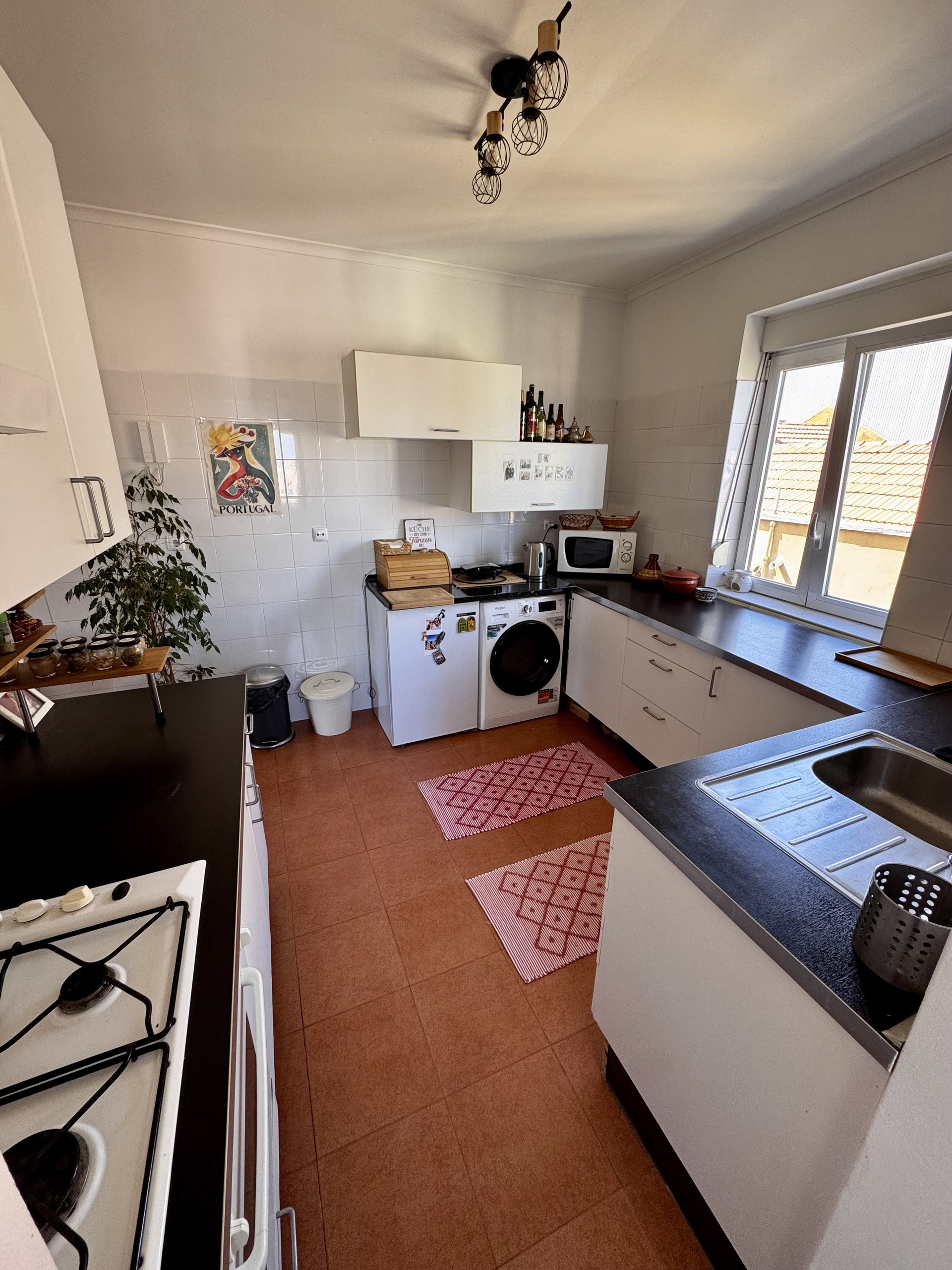 Bright kitchen with appliances and dining