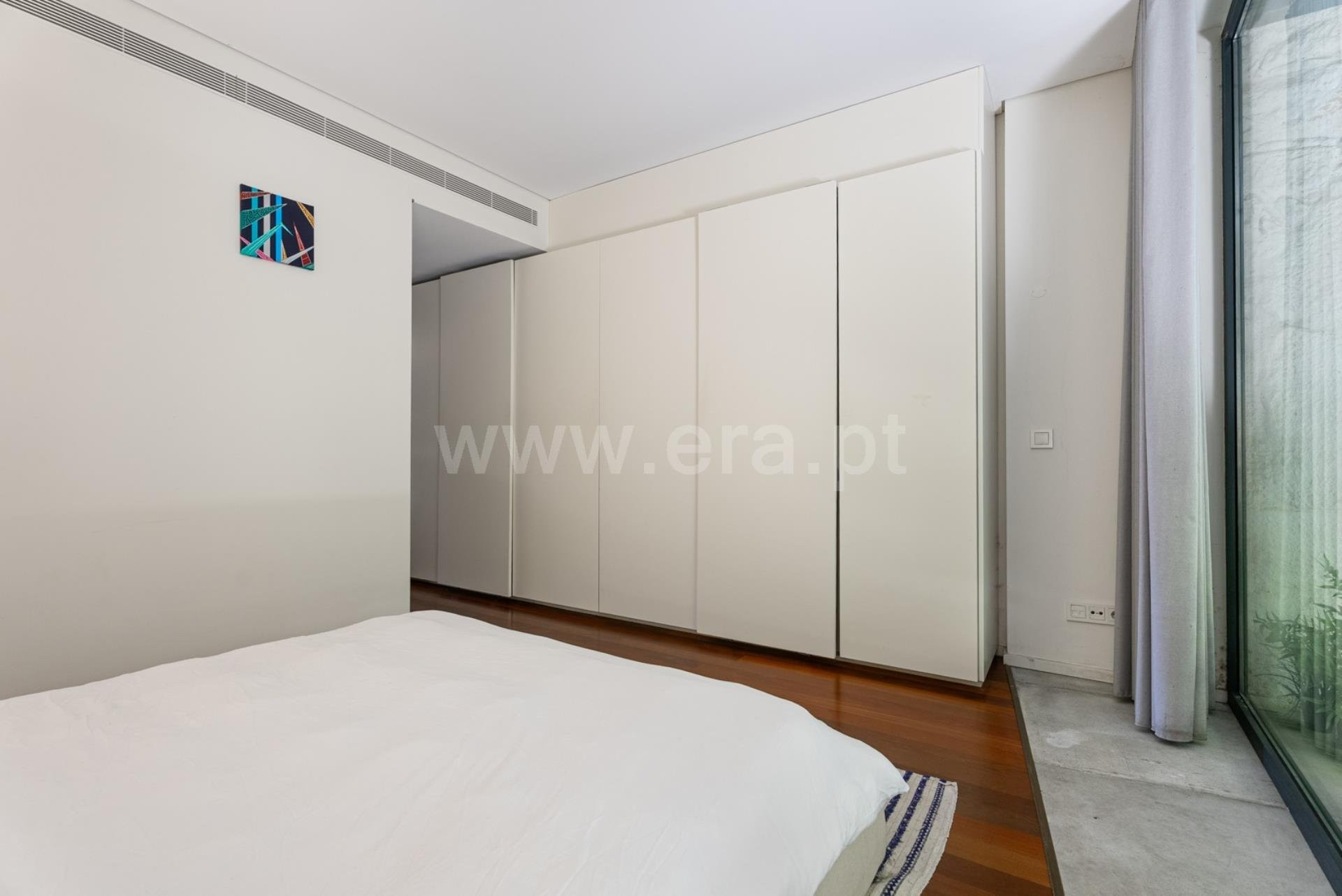 Bedroom with built-in white wardrobes