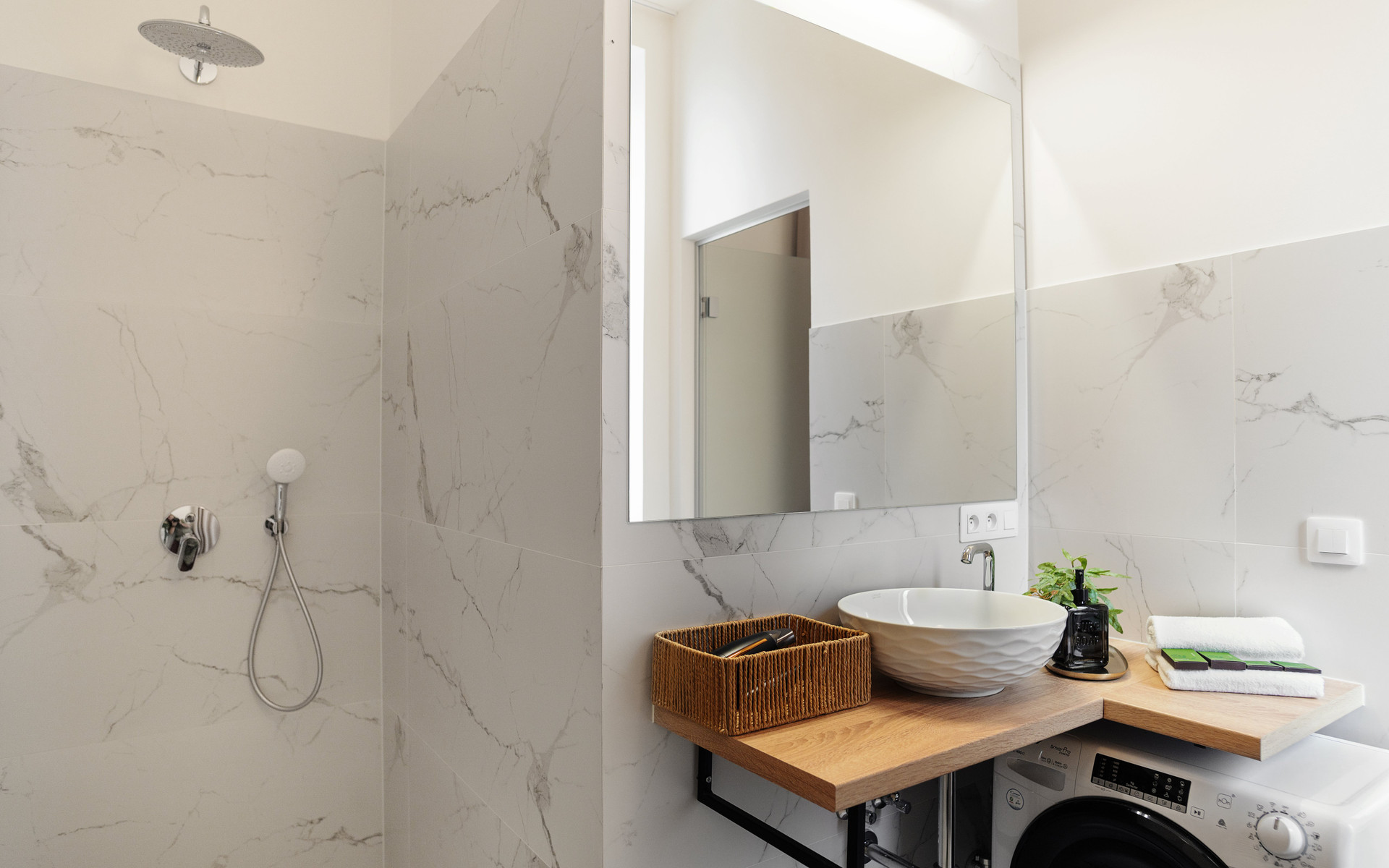 Marble bathroom with shower and washer