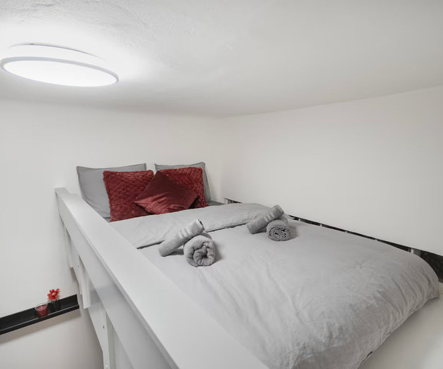 Loft sleeping area with ceiling light