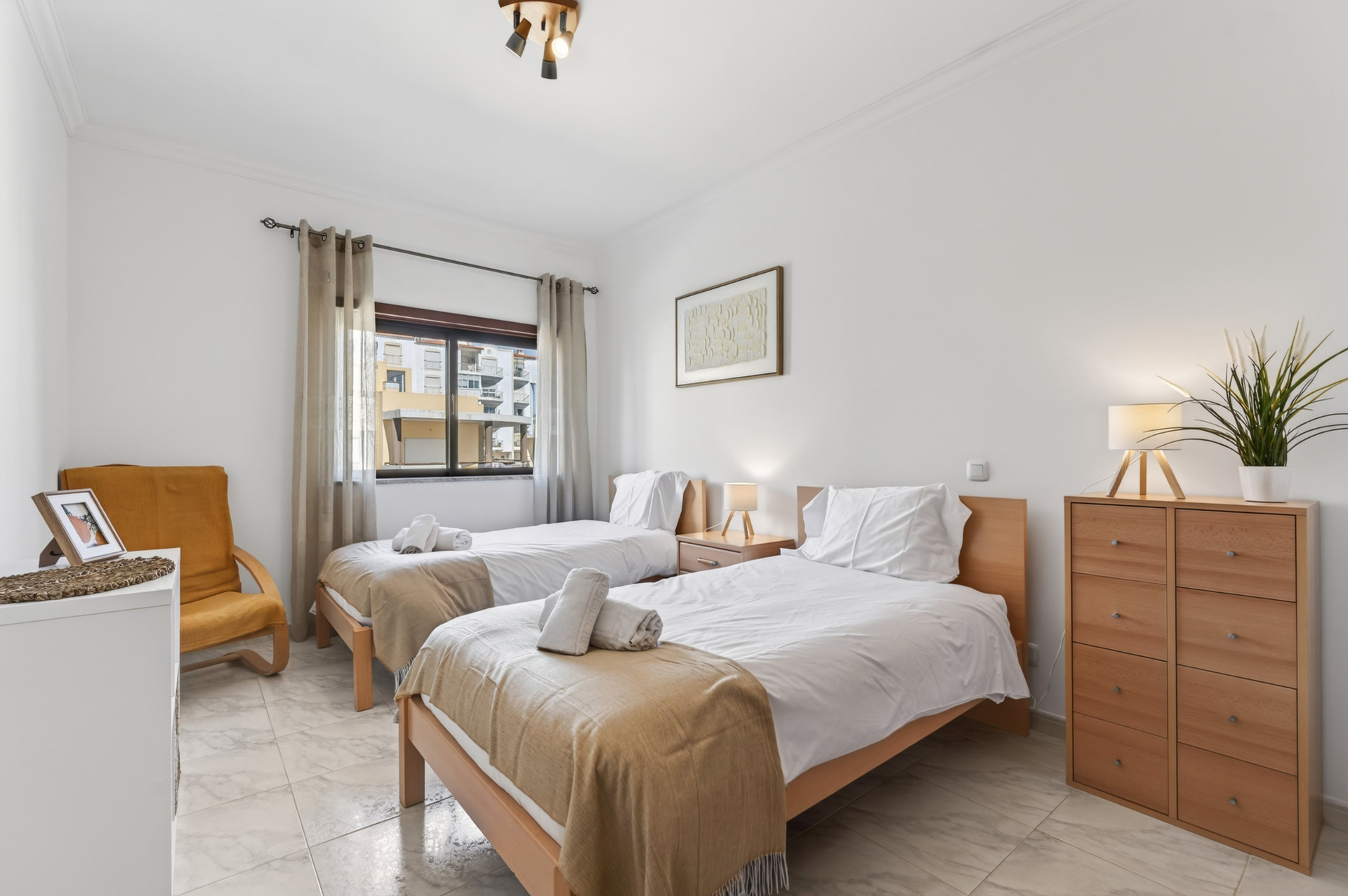Twin bedroom with wooden furniture