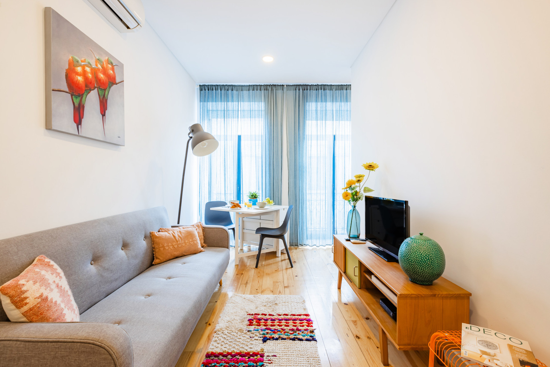 Living Room with a comfortable sofa and TV. Dining Table for 2.