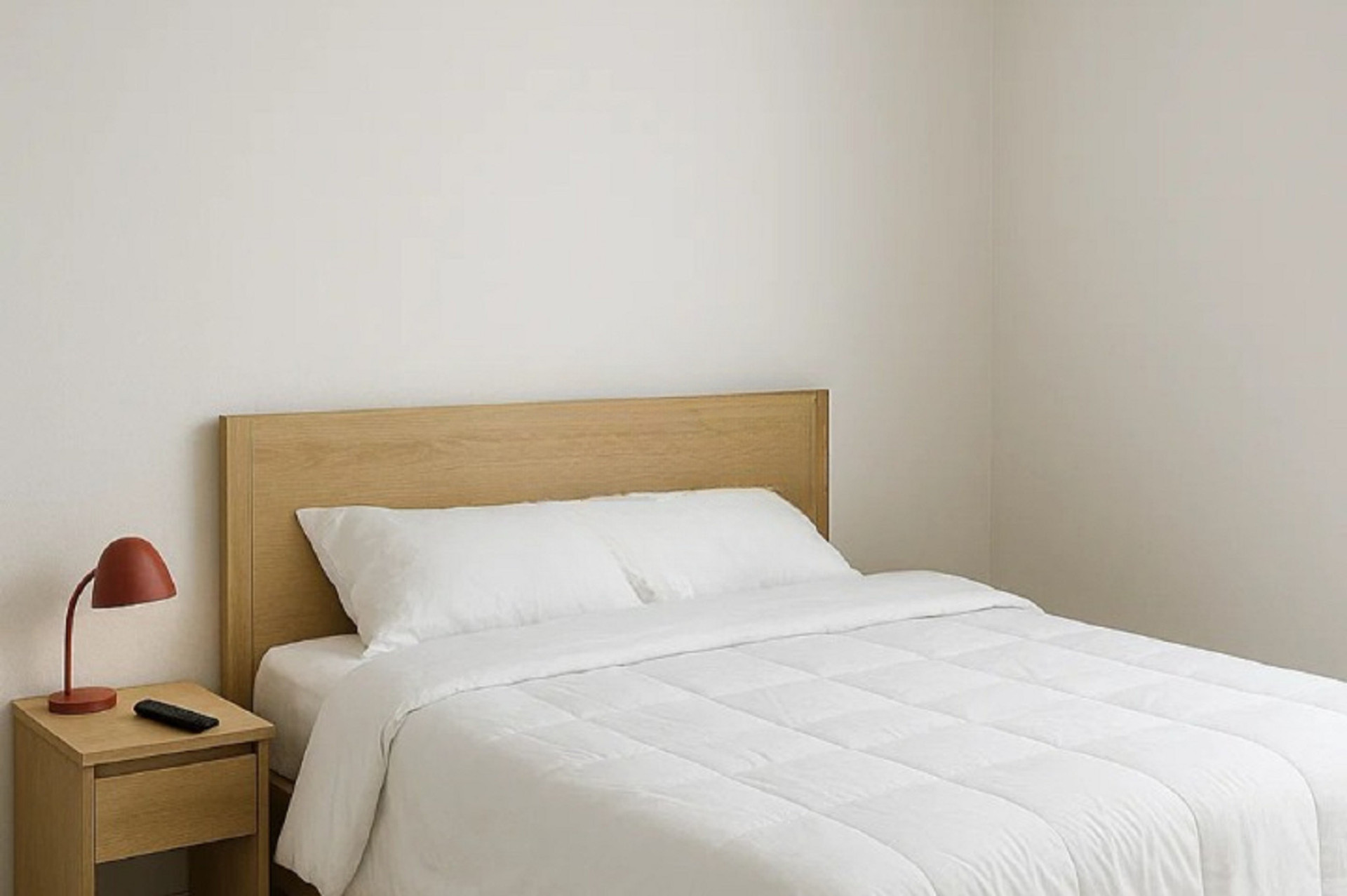 Spacious master bedroom with a large, comfortable double bed and a clean, minimalist design