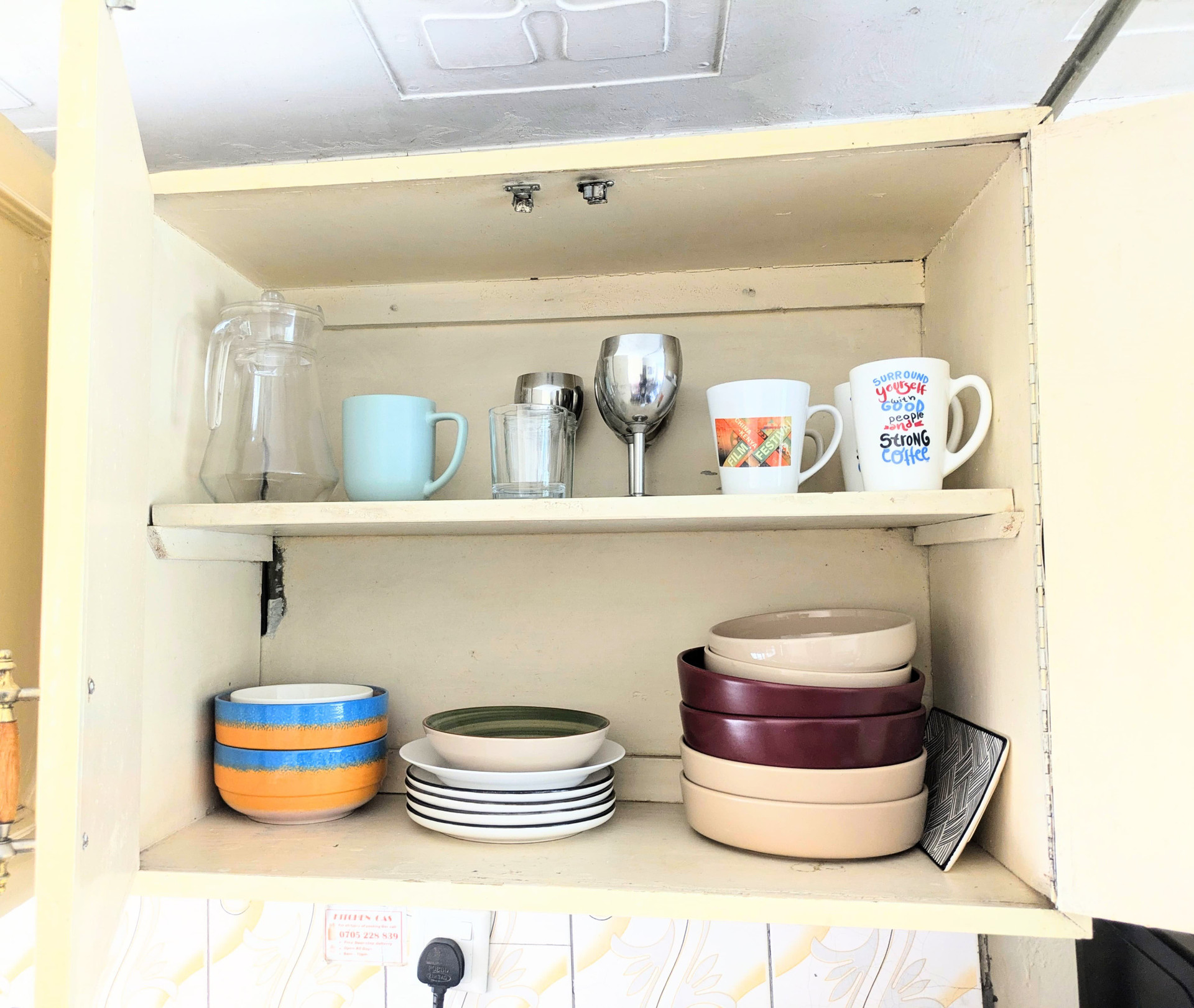 Kitchen cabinet with dishes cups