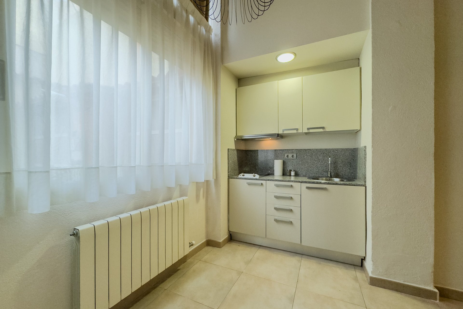 Compact kitchenette by window