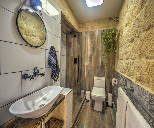 Rustic stone bathroom with rainfall shower