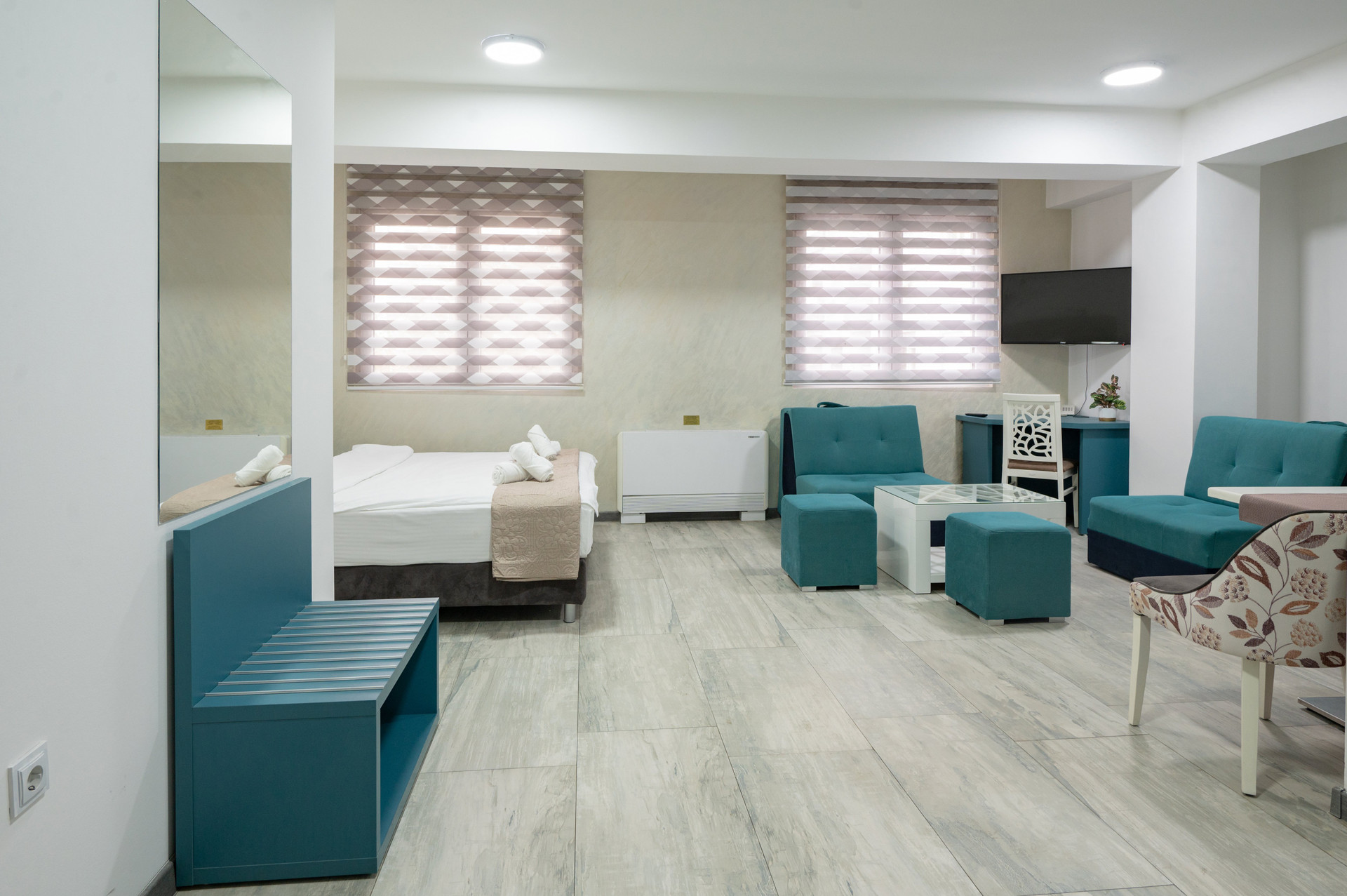 Spacious studio with teal furniture