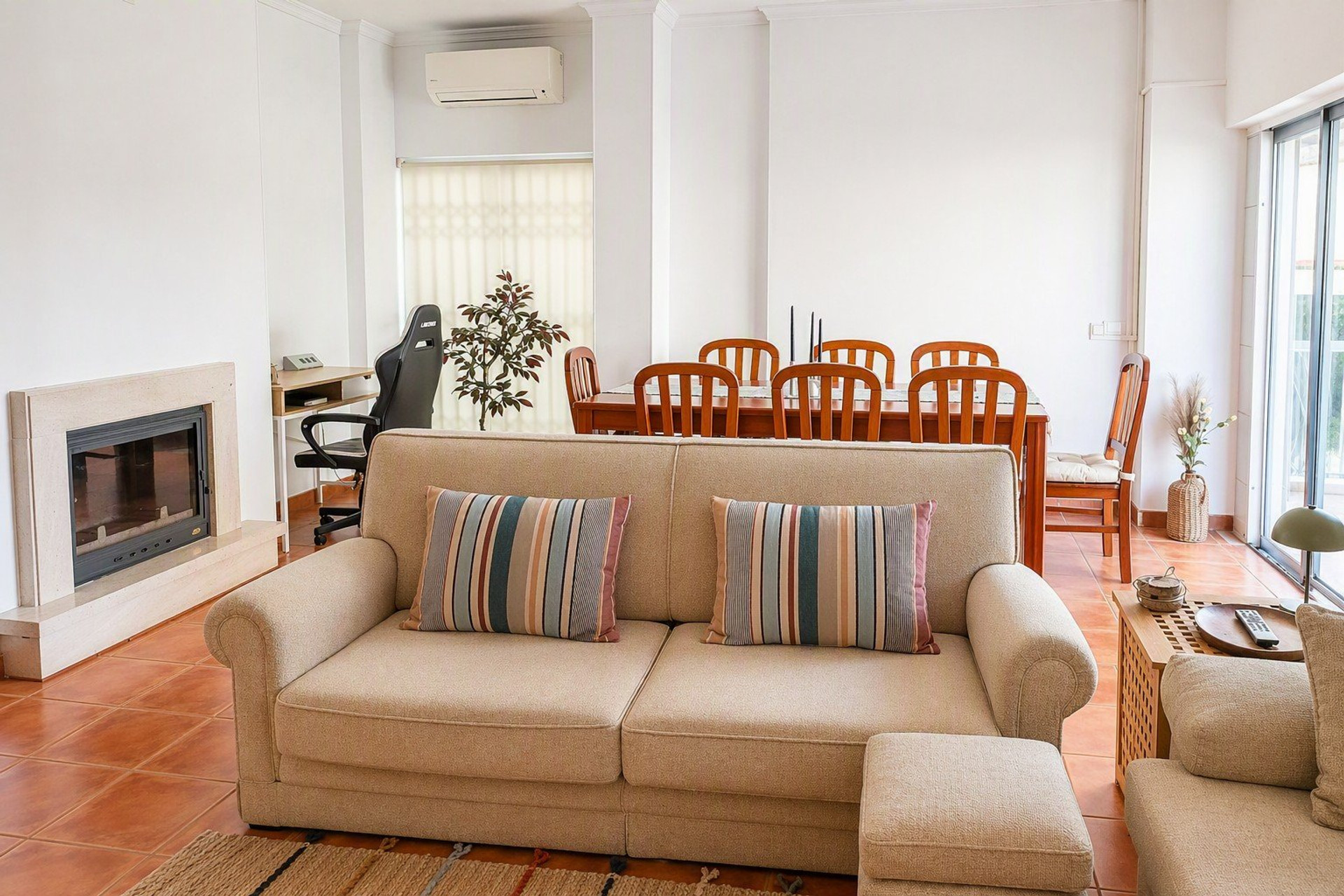 Living & Dining Room | Spacious open-plan living and dining area featuring air conditioning, a dedicated workspace, and comfortable seating 