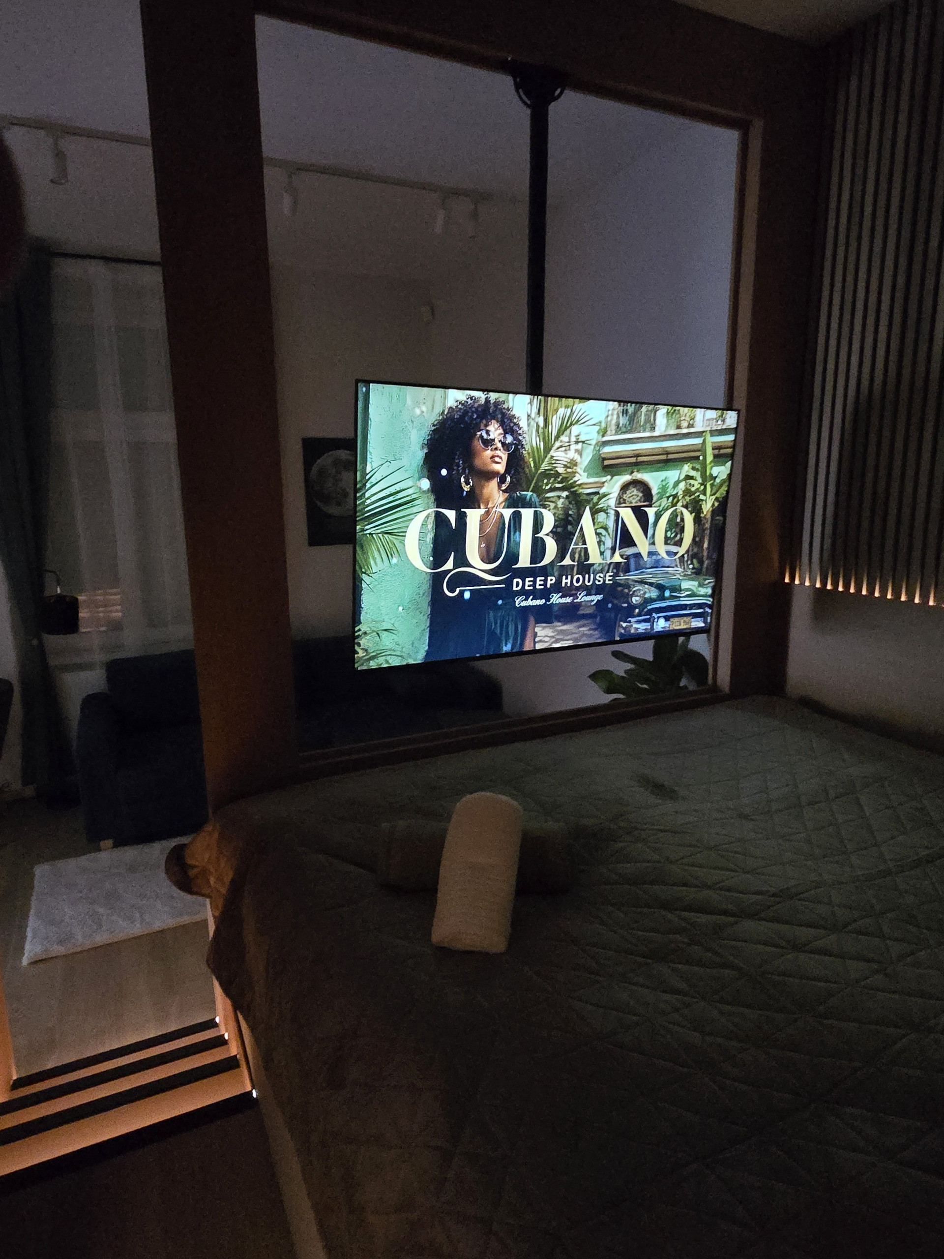 Bed and TV in evening light